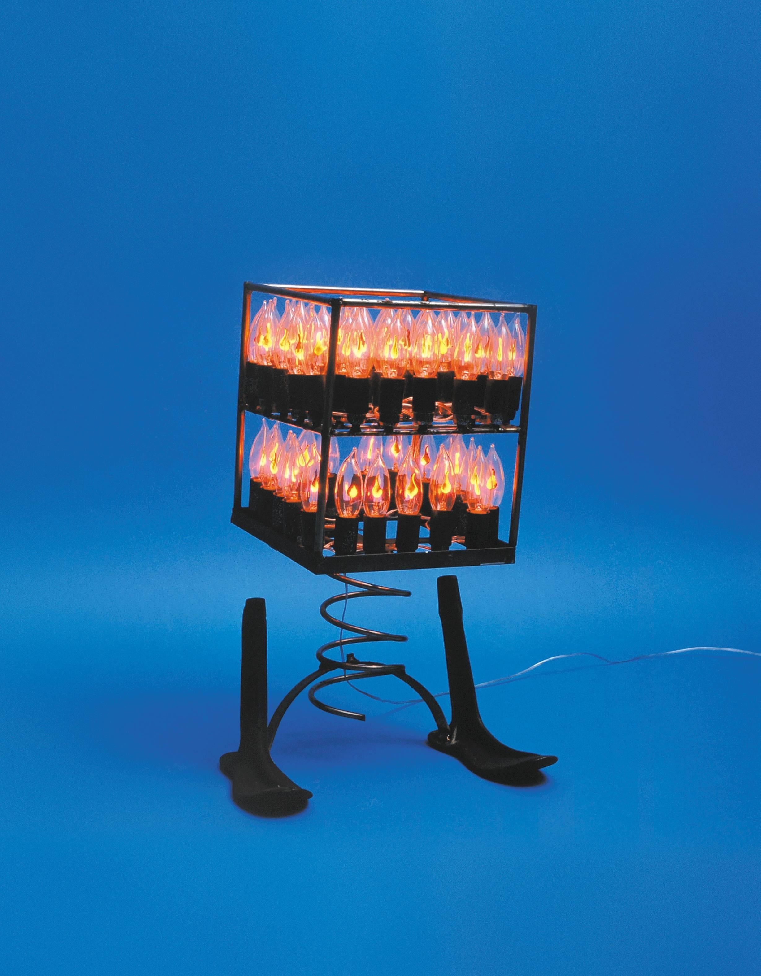 Italian, b. 1955, Bari, Italy.
Artist and filmmaker he lives and works in Rome. In the mid-nineties, he produced his first objects “flaming” made up of hundreds of flame bulbs that simulate the light of votive candles. Over the years he became a