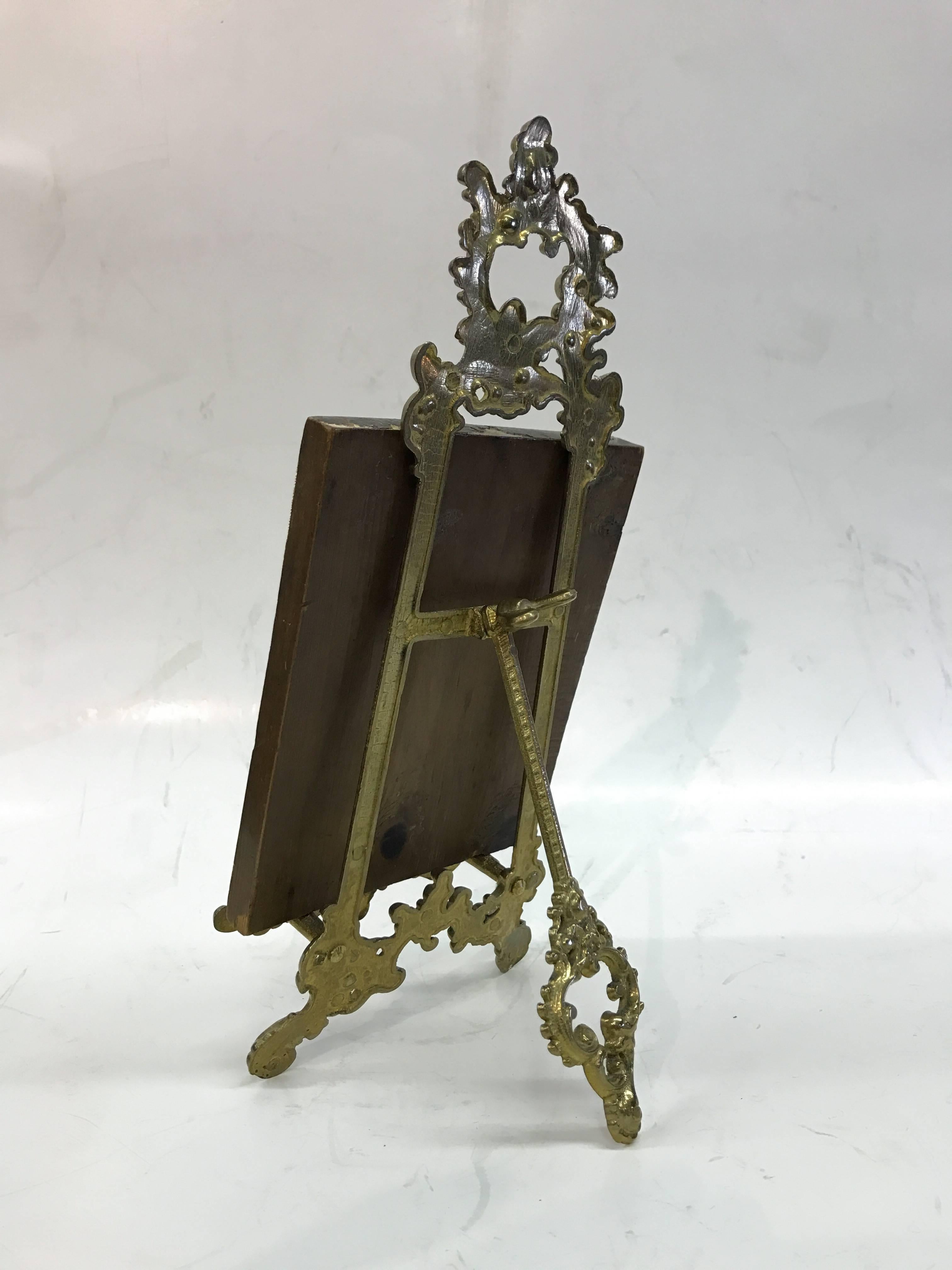 Russian icon painted on board with brass stand. 

