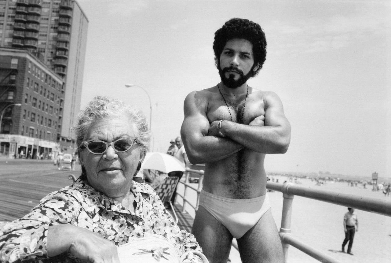 Arlene Gottfried Black and White Photograph - Angel and Woman on Boardwalk, Brighton Beach, NY