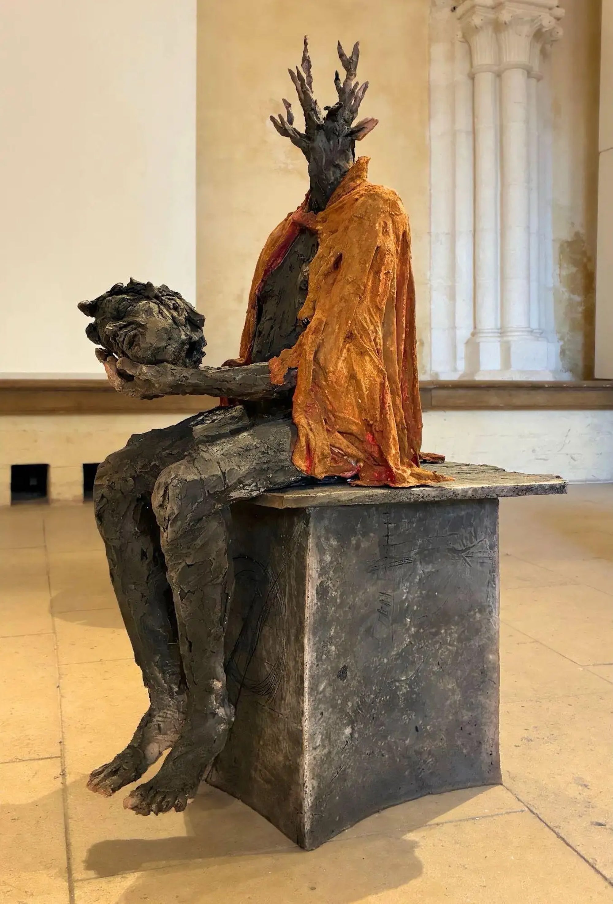 Cephalophore is a unique smoke-fired stoneware, resin, plaster and clay sculpture by French contemporary artist Cécile Raynal, dimensions are 84 × 40 × 58 cm (33.0 × 15.7 × 22.8 in). This sculpture is unique and comes with an authenticity