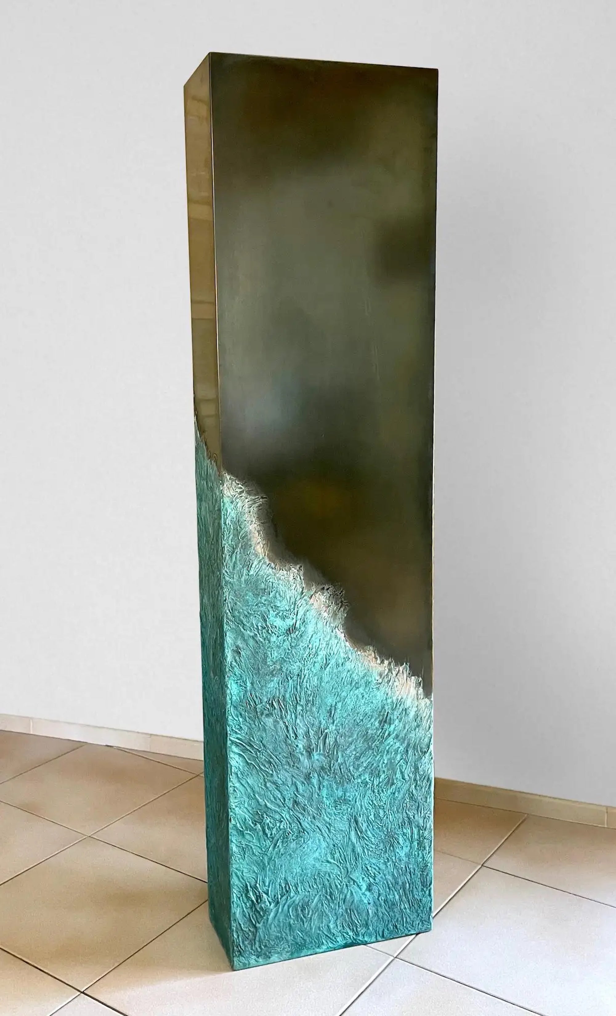 Totem (large) is a sculpture by French contemporary artist Frédérique Domergue. The sculpture is made with oak slat, waxed medal bronze and verdigris oxidized bronze on the sculpted part, dimensions are 130 × 33 × 15 cm (51.2 × 13 × 6 in).
The