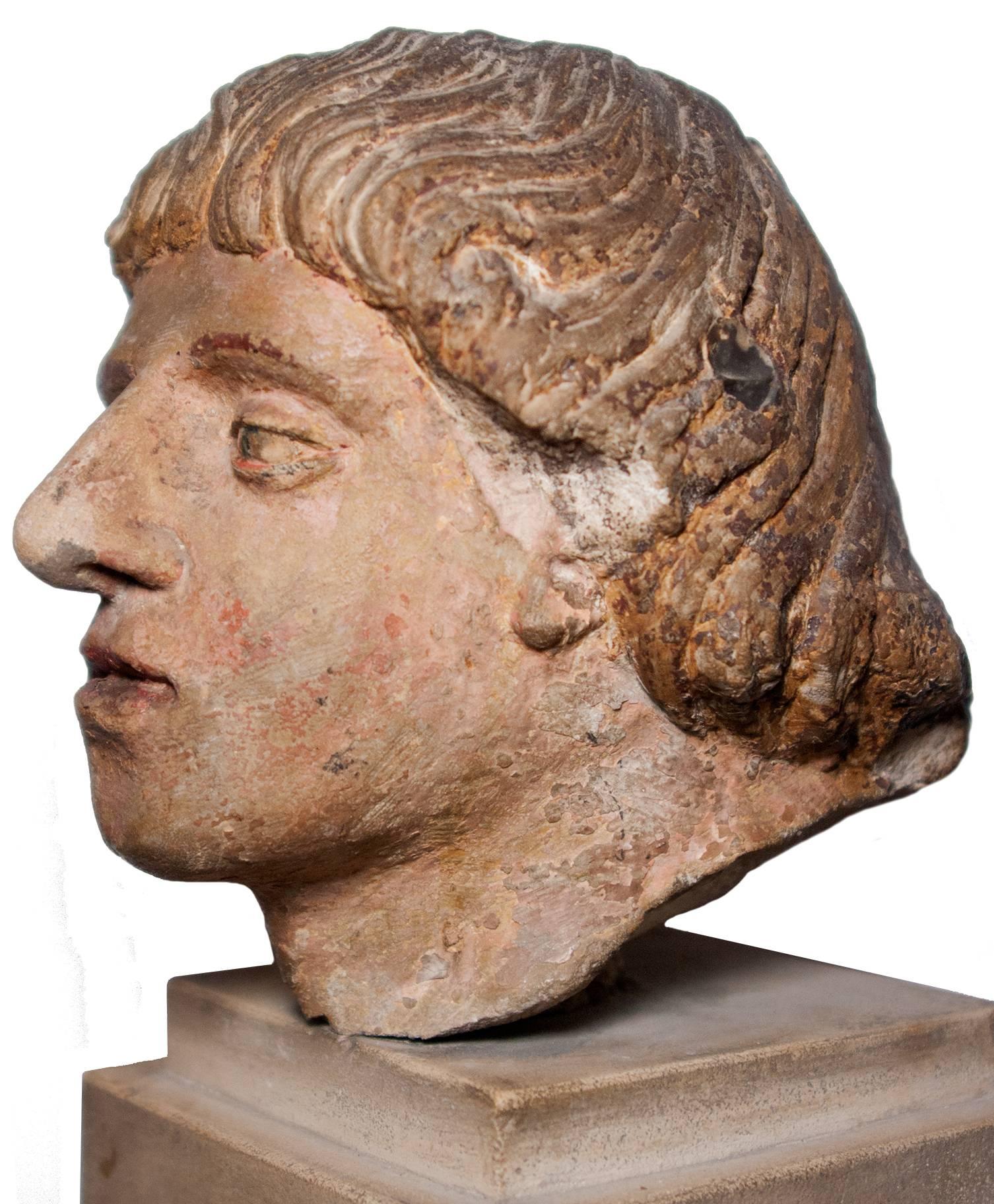 Head of a saint in painted limestone, XV th century - Sculpture by Unknown