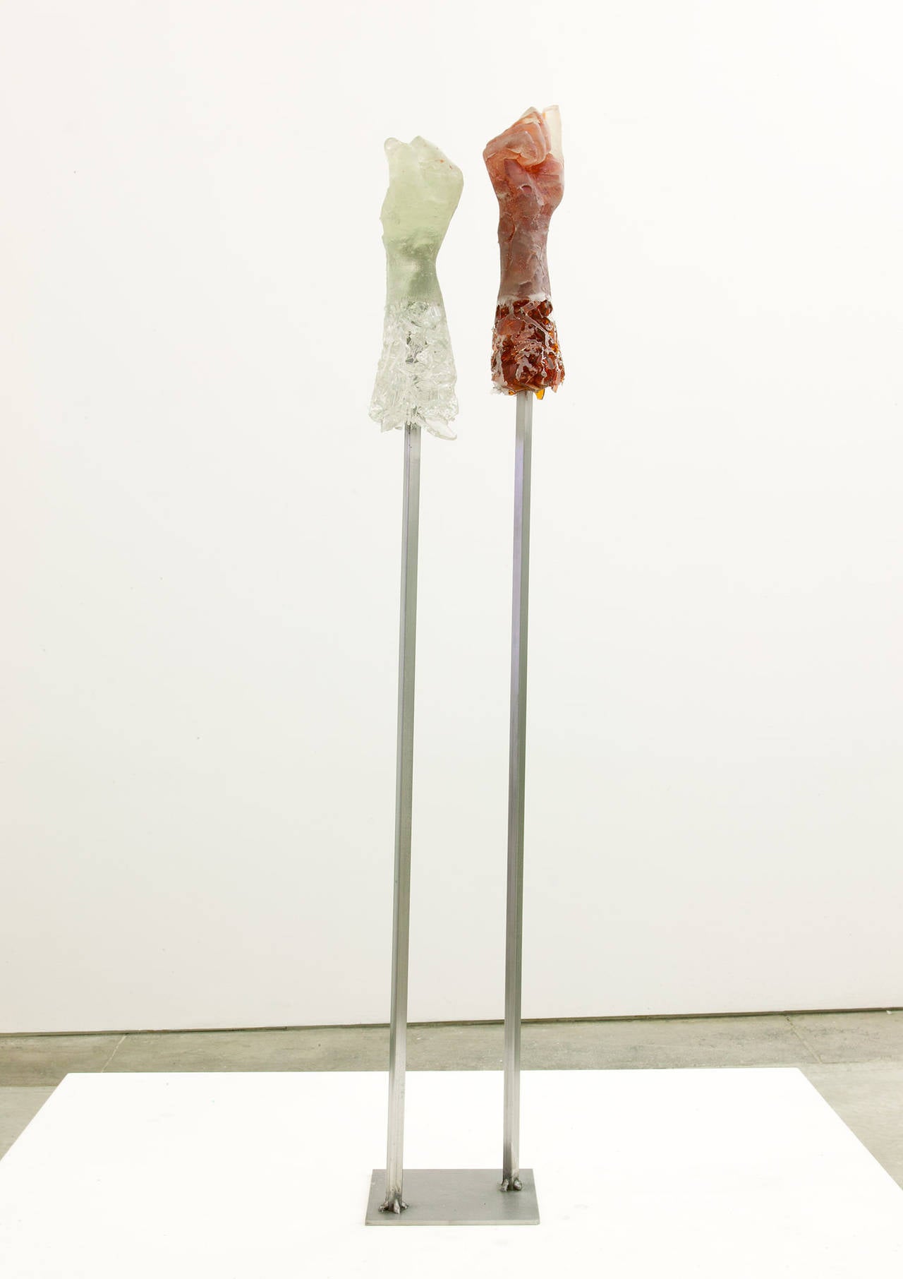 Owens is known for her sculpture made from recycled material, especially broken glass. This work is from her series of POPs. Broken bottle glass was cast in molds made from several different women, and the hands are mounted on lifts as in a