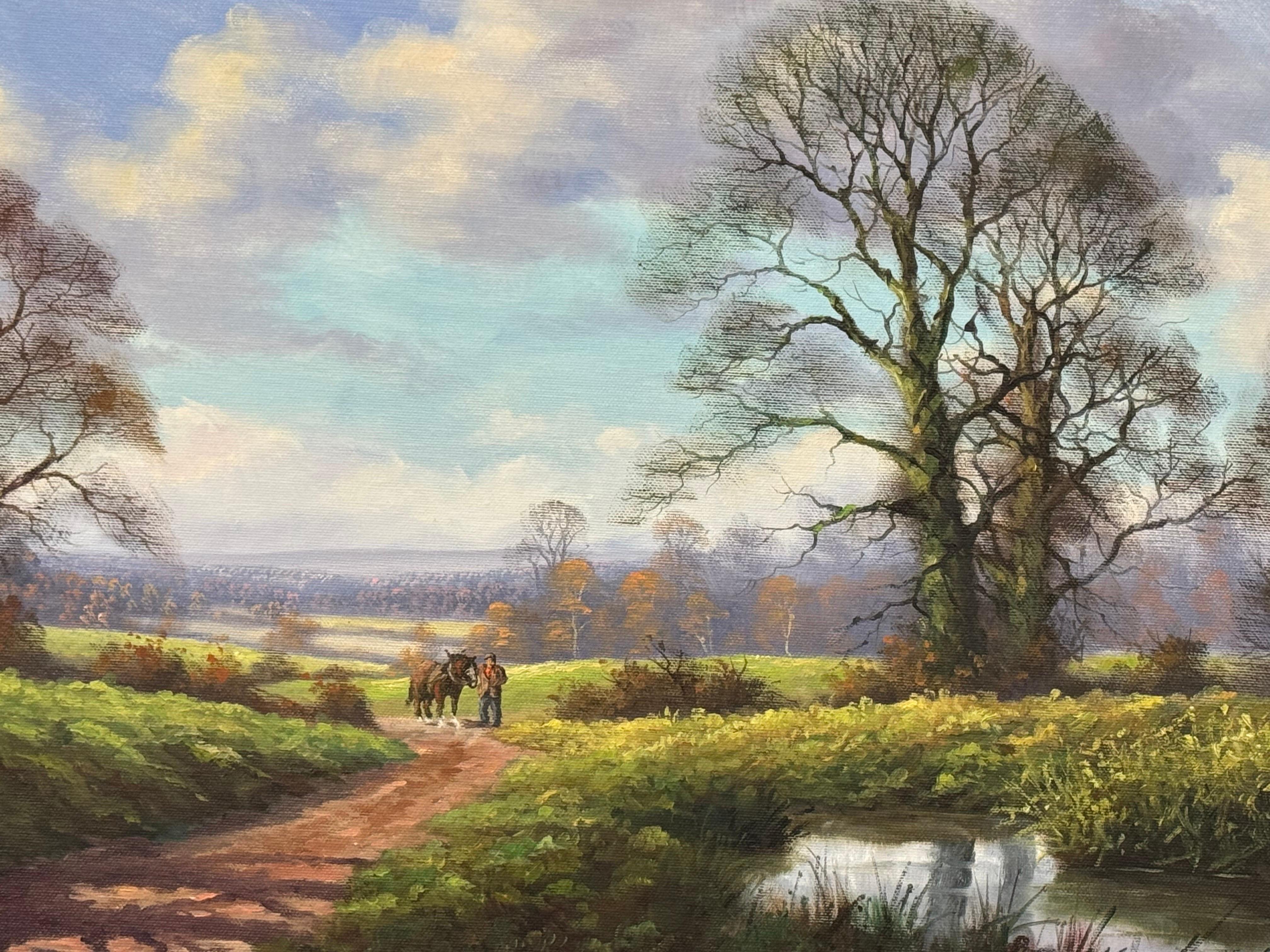 Caballo de Shire y hombre junto a río arbolado en la campiña inglesa por artista británico - Painting de Peter J Greenhill