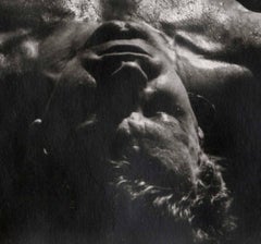 Lying in Water (Erotic nude male lies on beach as surf rushes around his body)