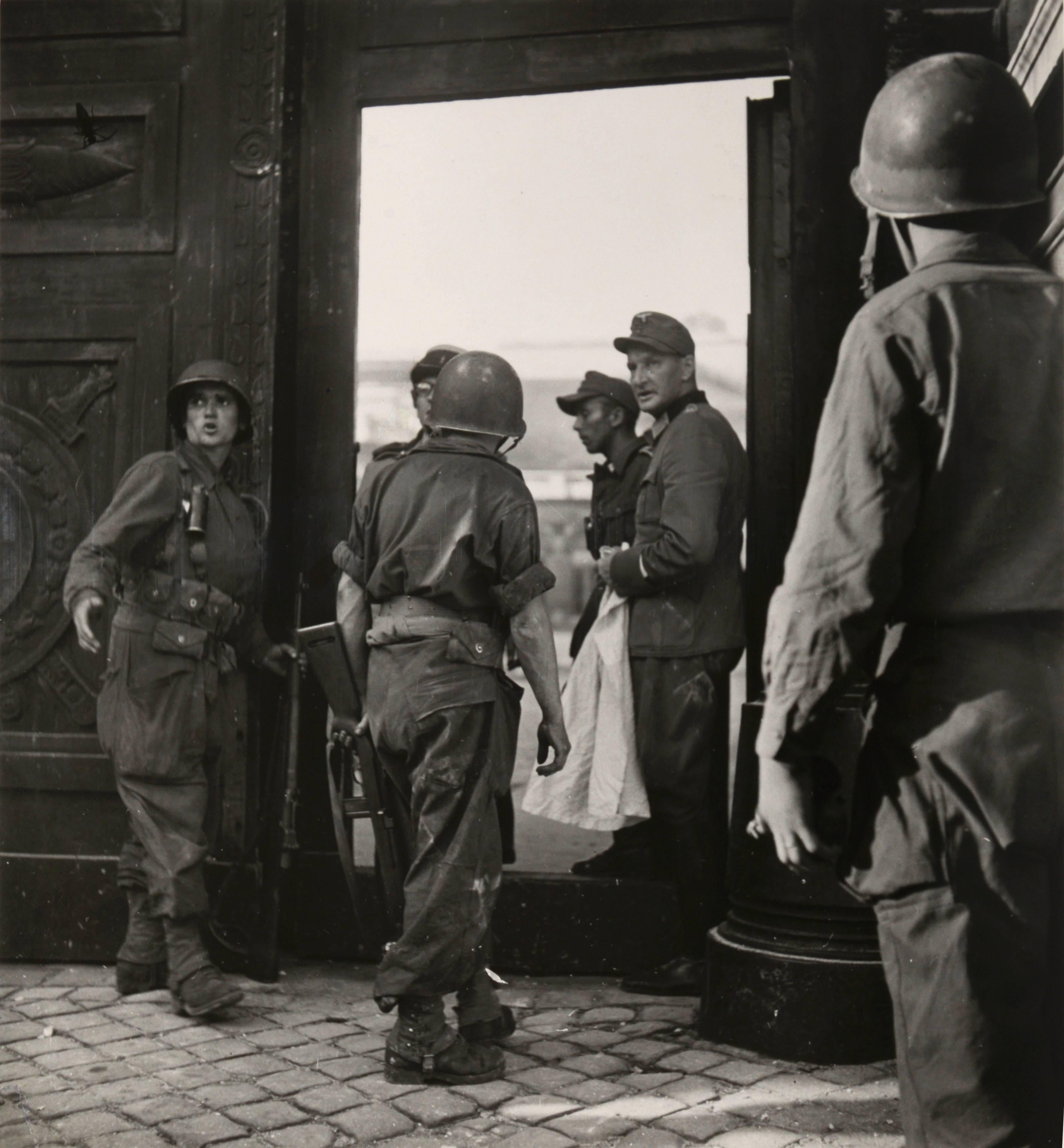 Robert Capa Black and White Photograph - Captured German Officer with Allied Soldiers During Paris Liberation 