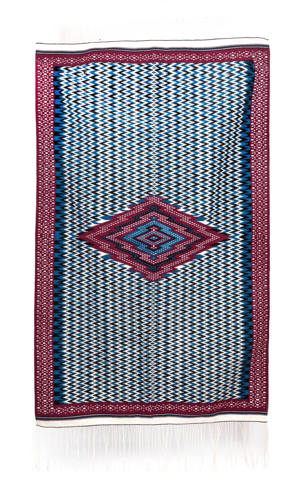 FREE SHIPPING TO WORLDWIDE!

Artisan: Arnulfo Xochitiotzin Cocoletzi

MASTERPIECE

Replica of the Serape of Saltillo made in colonial treadle loom with Silk and Australian Wool and Gold threads. Design recovery from century XVIII.

- Dimensions: 81"