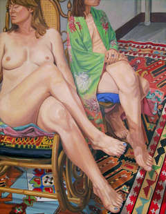 Two Female Models Sitting with Legs Crossed and Kazak Rug