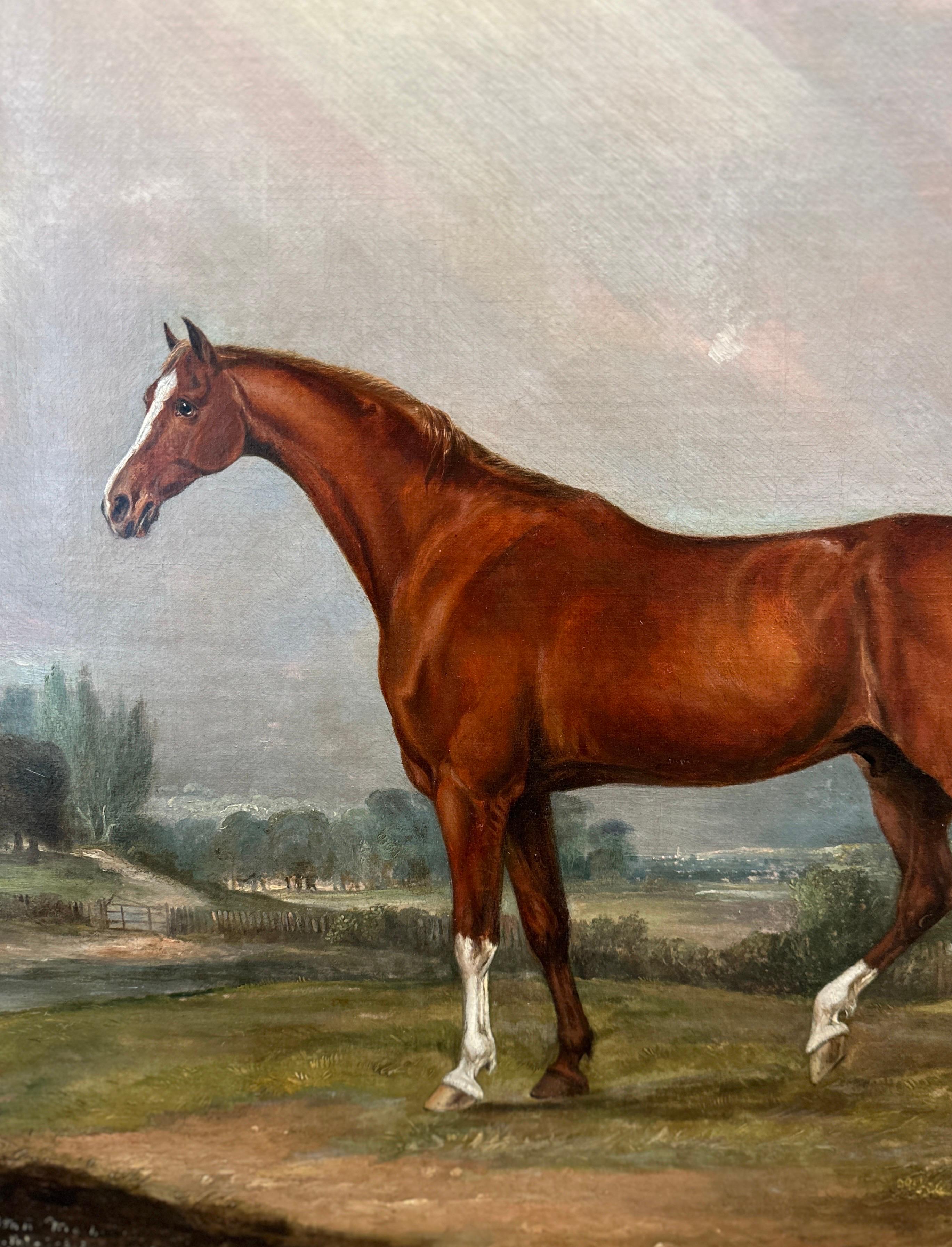 A painting of a chestnut hunter in a landscape with a horse and rider accompanied by two hounds by a woodland river in the distance.

Signed and inscribed 'Melton Mowbray', lower left. 

Oil on canvas in a giltwood frame.

 John Ferneley Sr