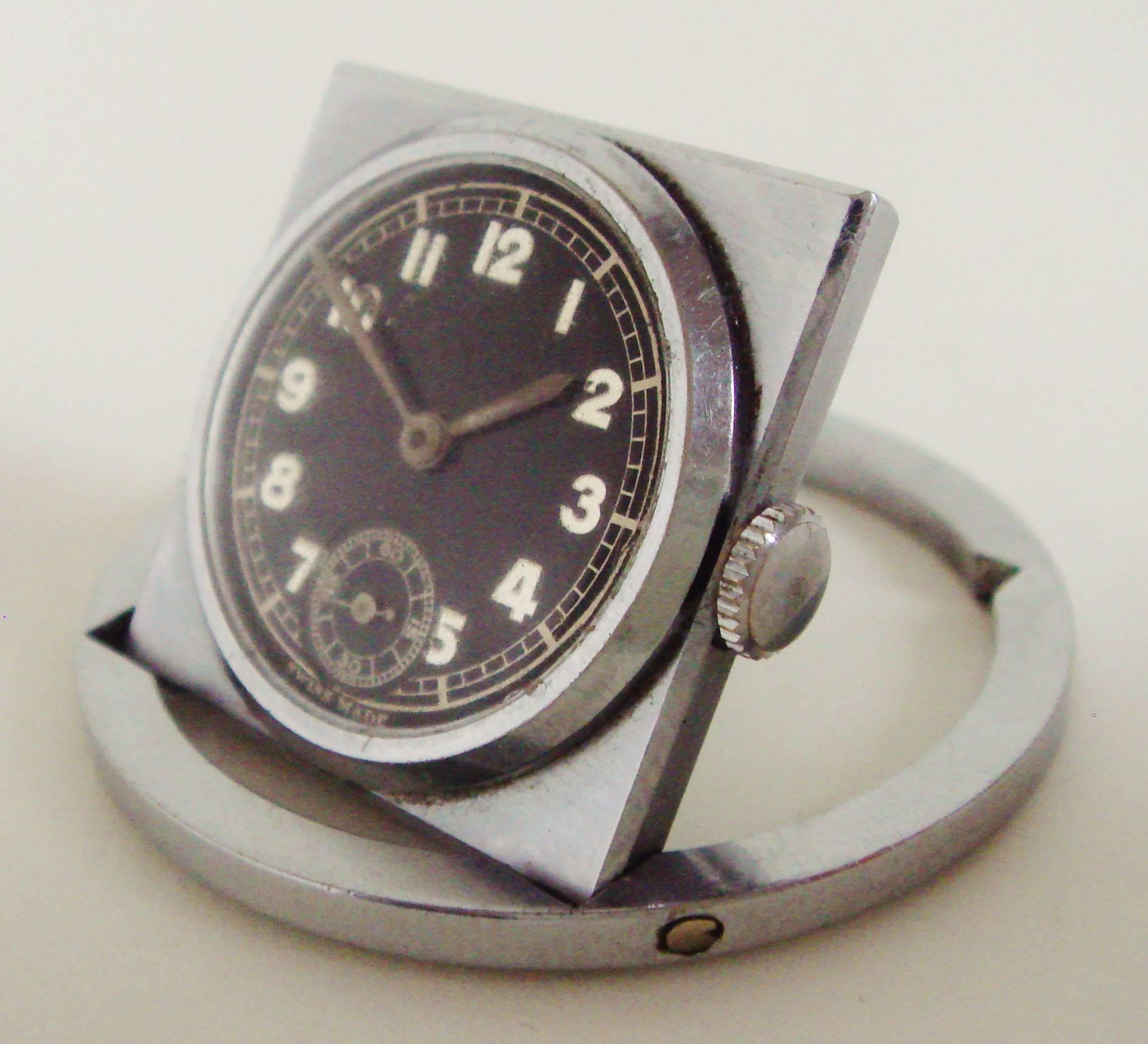 This functional Swiss Art Deco chrome/steel folding traveling watch can be used as both a bedside/desk clock and a pocket watch. Its stylish tilting geometric design is a triumph of simplicity, it is working well and save for a scratched owners name