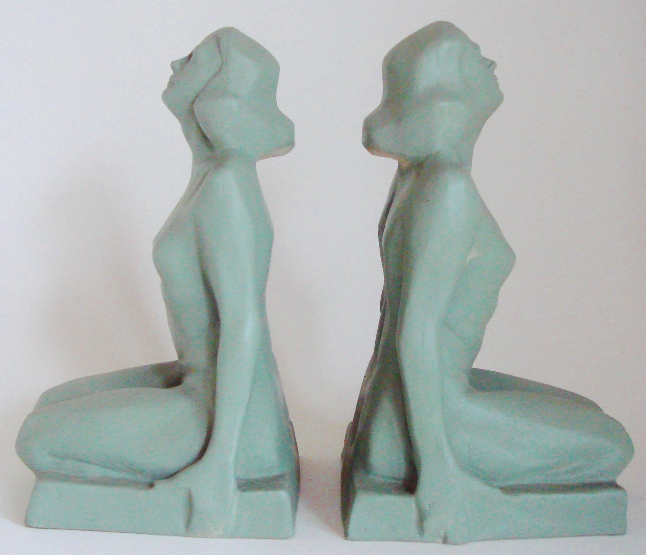 This stylish pair of hollow-cast American Art Deco female nude figural bookends are beautifully sculpted and painted in a soft Lovat green. They are in excellent condition with one being signed B.Foley to the underside of the base.