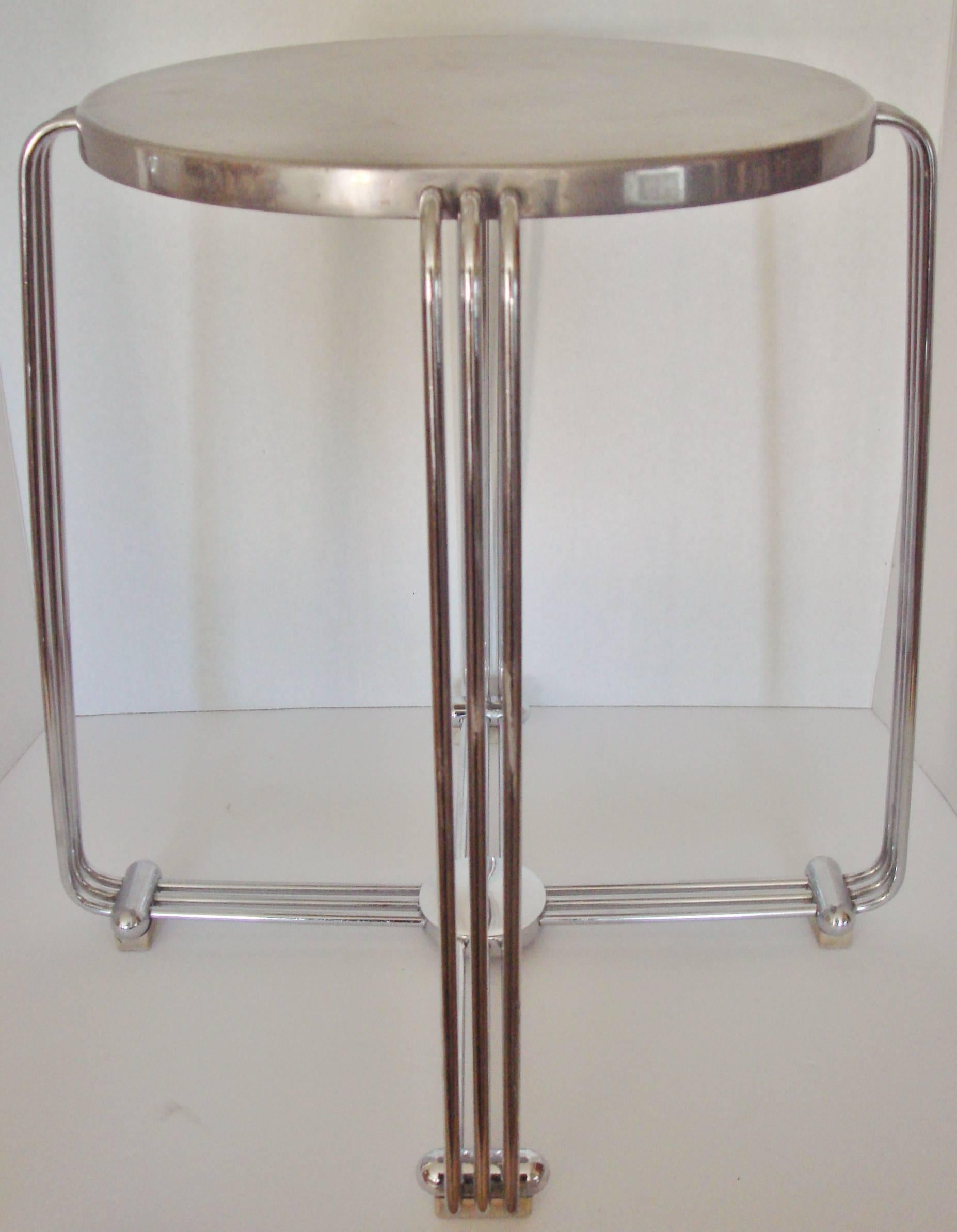 This example of the iconic Alpax English Art Deco side table or stool consists of a chrome four legged base with blonde block wood feet and a cast aluminium top. It is signed to the underside with the 'Alpax' logo in an Art Deco style, has all its