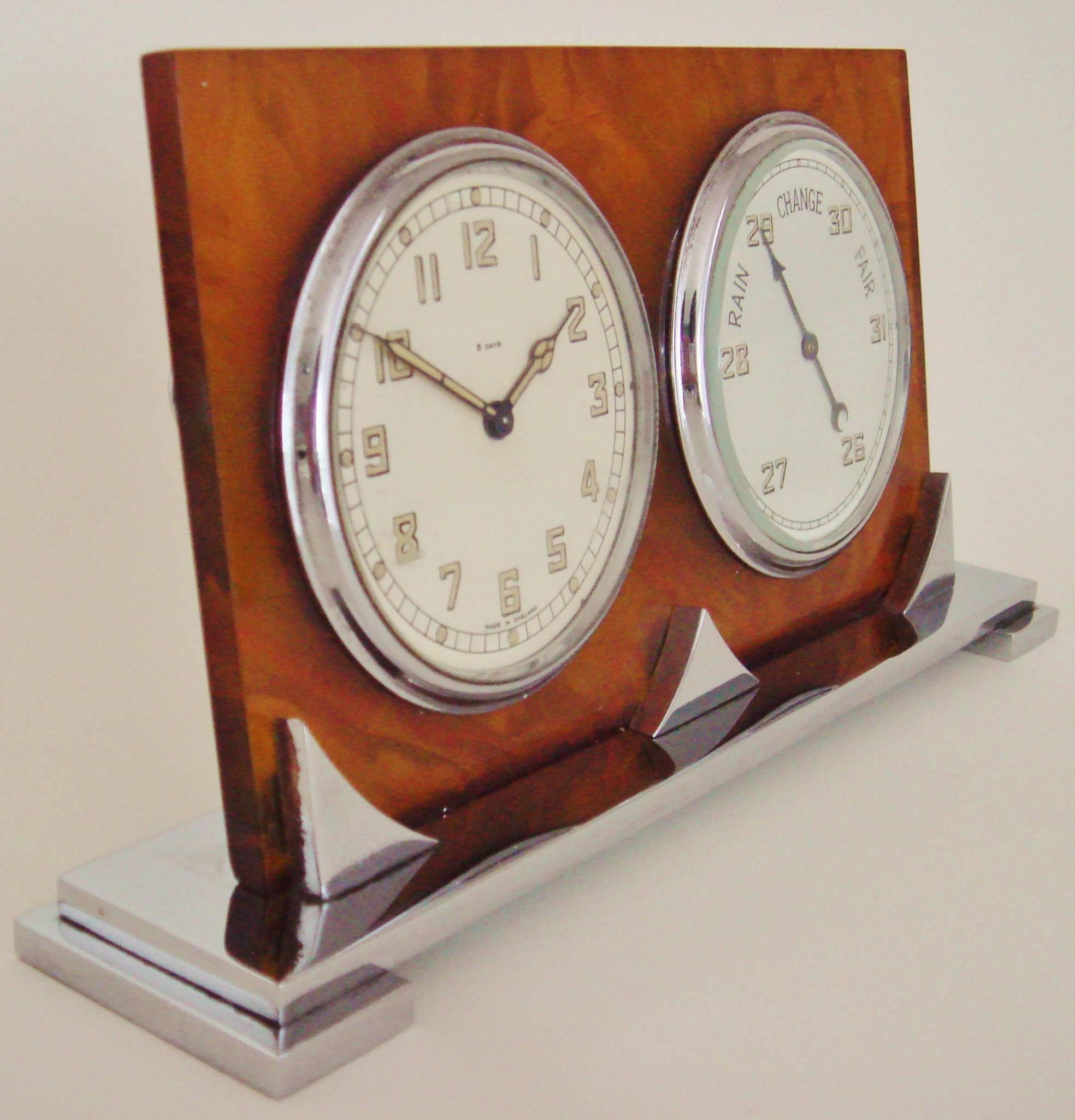 This very stylish English Art Deco combination 8-day desk clock and barometer is by Smiths. It features a stepped chrome base with three triangular supports that hold an oblong backplate of tortoiseshell Bakelite. This is pierced to hold a