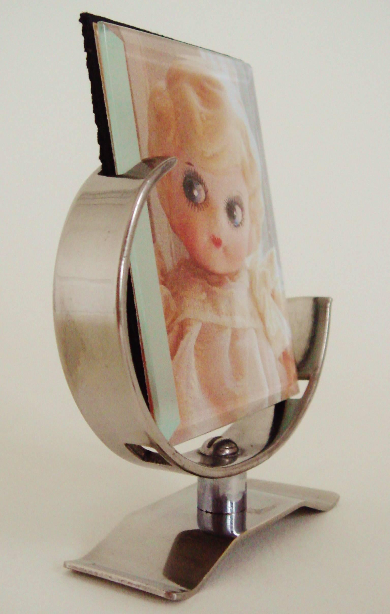 This very rare and fabulous pair of miniature German Art Deco nickel-plated picture frames were made to be in scale with the dolls of the period. They are book matched and notched so that the image is correctly angled back. The original glass in