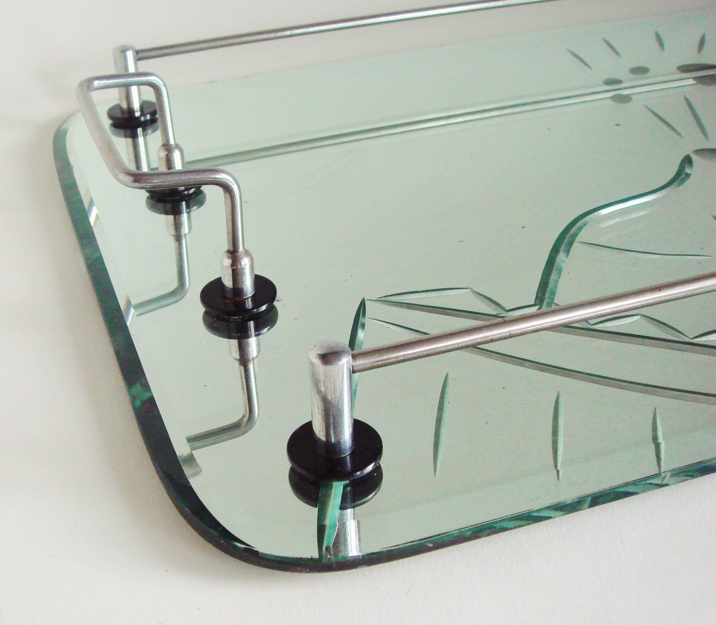 The deep etched mirror on this Australian Art Deco cocktail tray features a exuberantly rendered champagne bucket containing a bottle with the cork exploding out plus a flying martini glass and olive on a stick. The handles and gallery are plated in