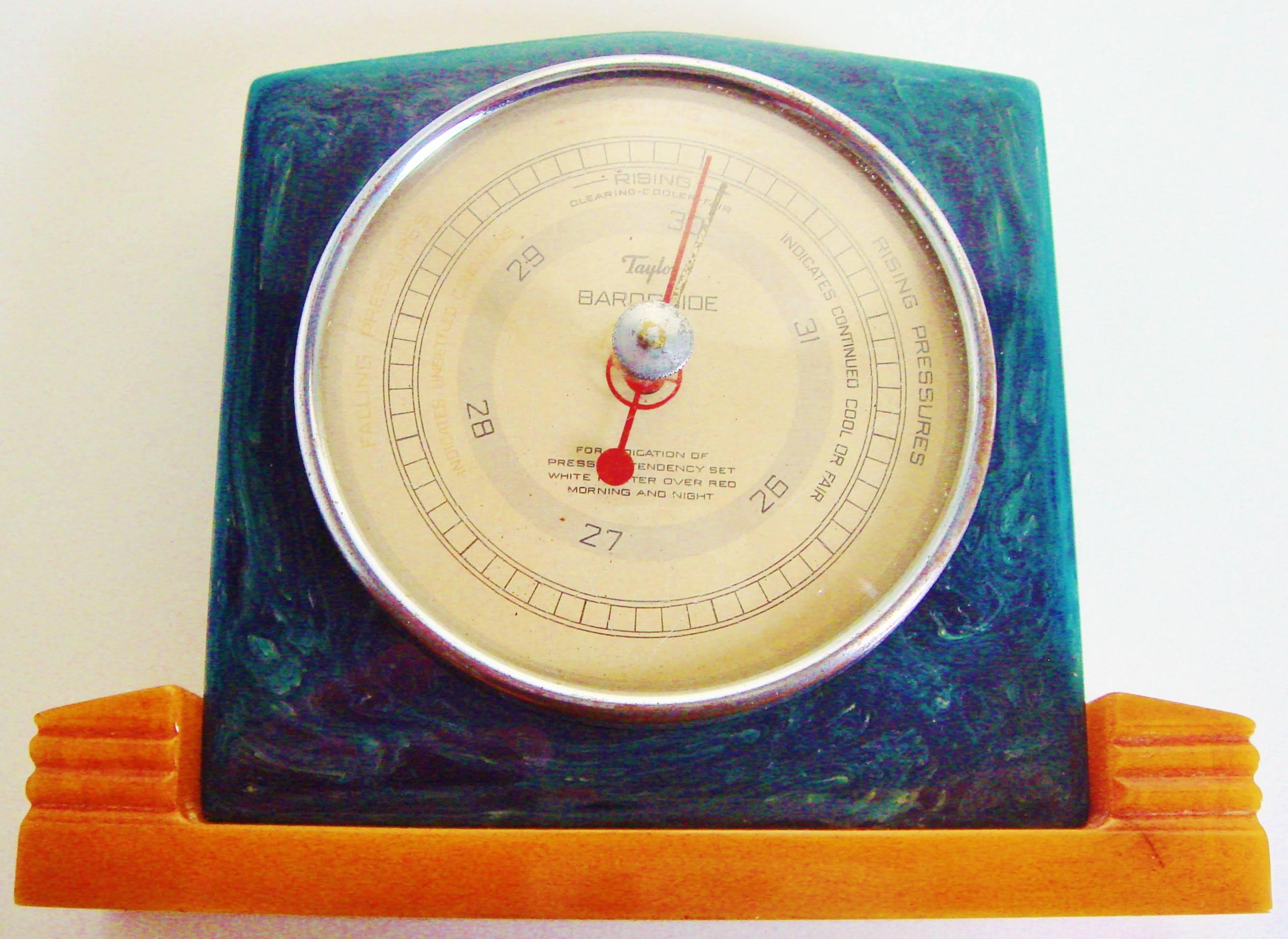 This pair of American Art Deco desk Baroguide barometer and hygrometer each feature the rare colour combination of a blue marbled Catalin/Bakelite  body mounted to a butterscotch Catalin/Bakelite base. The distinctive design of these desk pieces