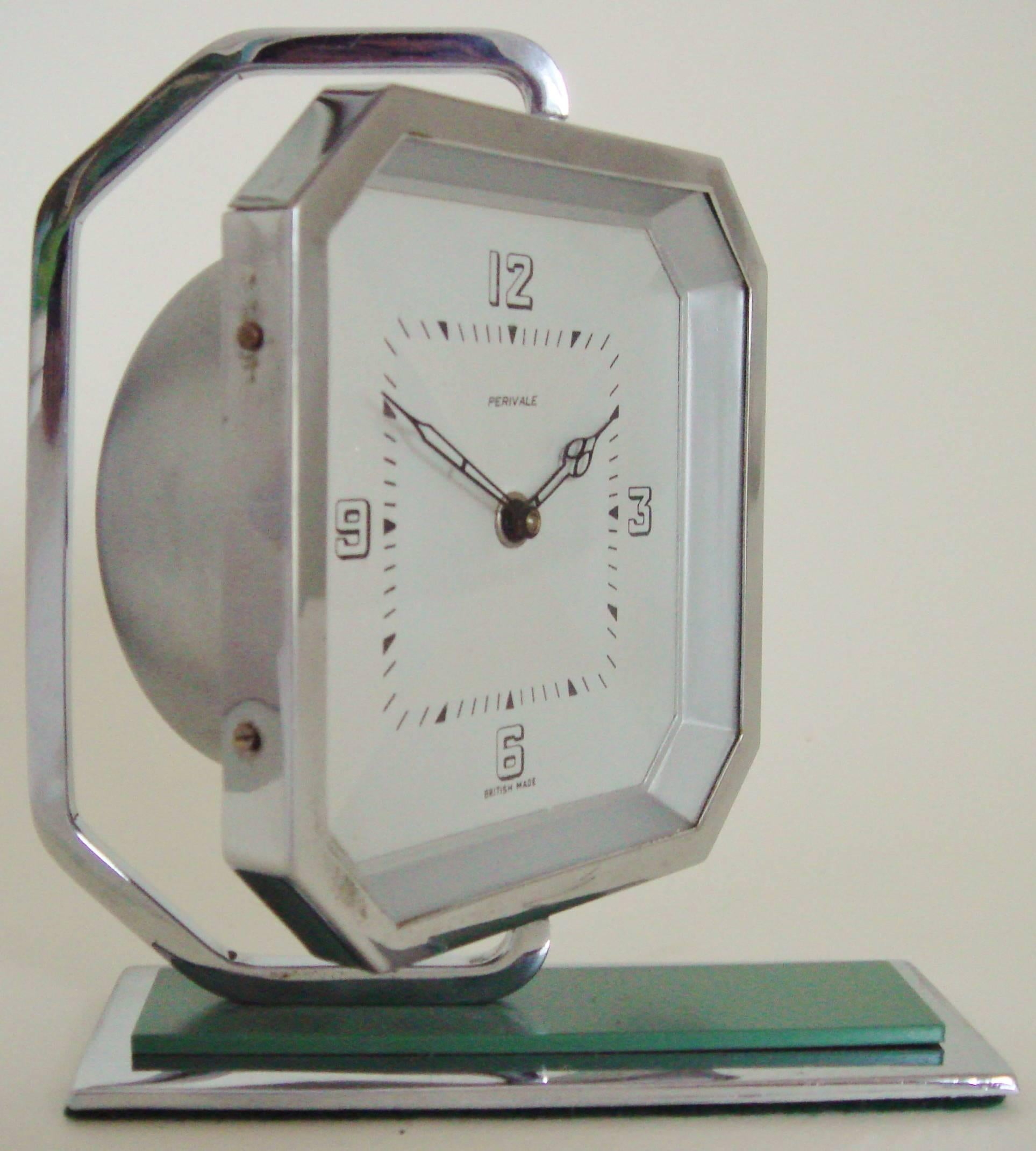 This beautifully designed English Art Deco chrome plated swivel desk clock is mounted on an eau-de-nil green painted stepped base and is by the Perivale British Clock Company of Greenford, Middlesex. The swivel arm is sympathetically shaped to echo