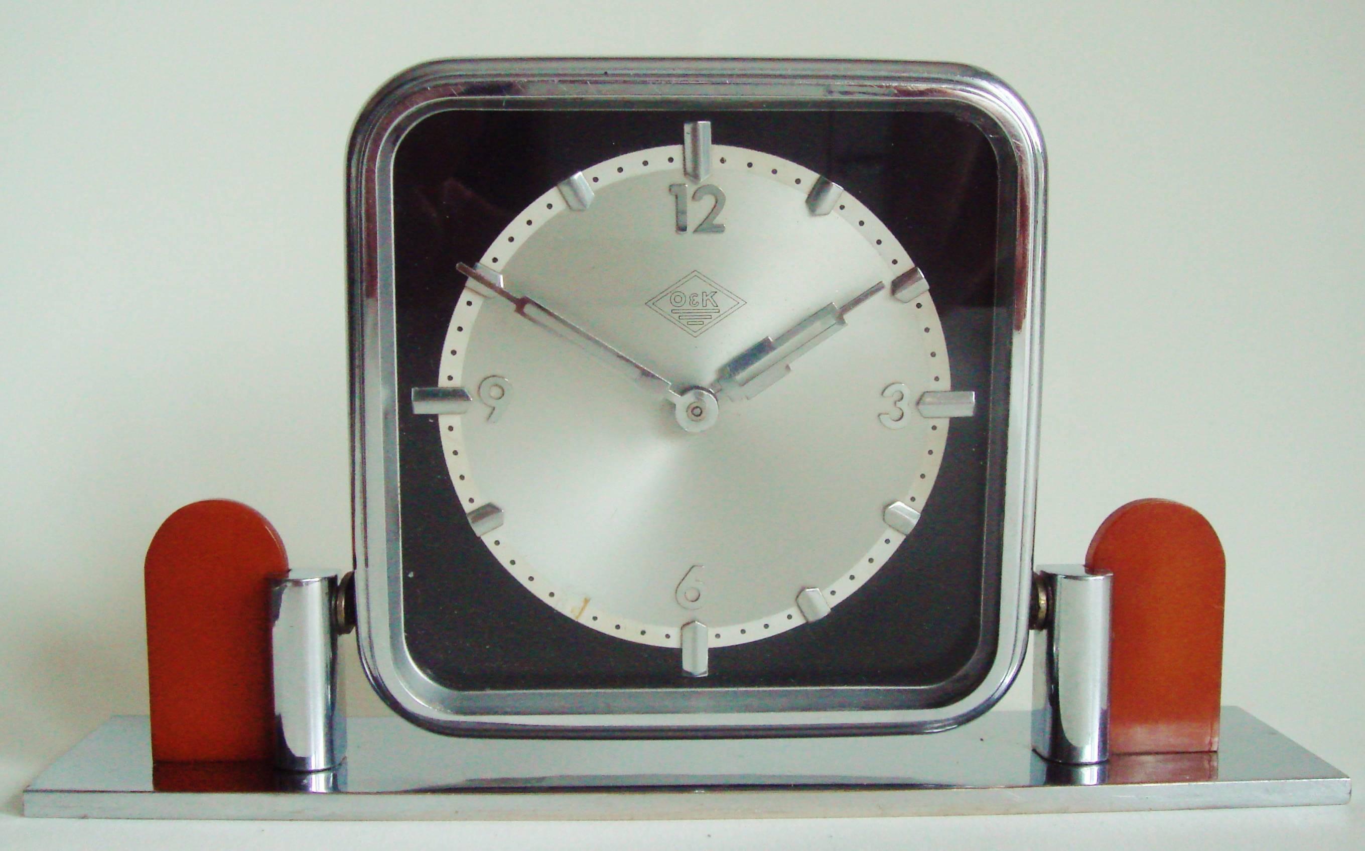 This German Art Deco tilting chrome and bakelite mechanical table clock was a presentation piece from the German heavy goods and engineering company of Orenstein & Koppel and bears their inter-war logo to the face. In 1935 as part of Hitler's