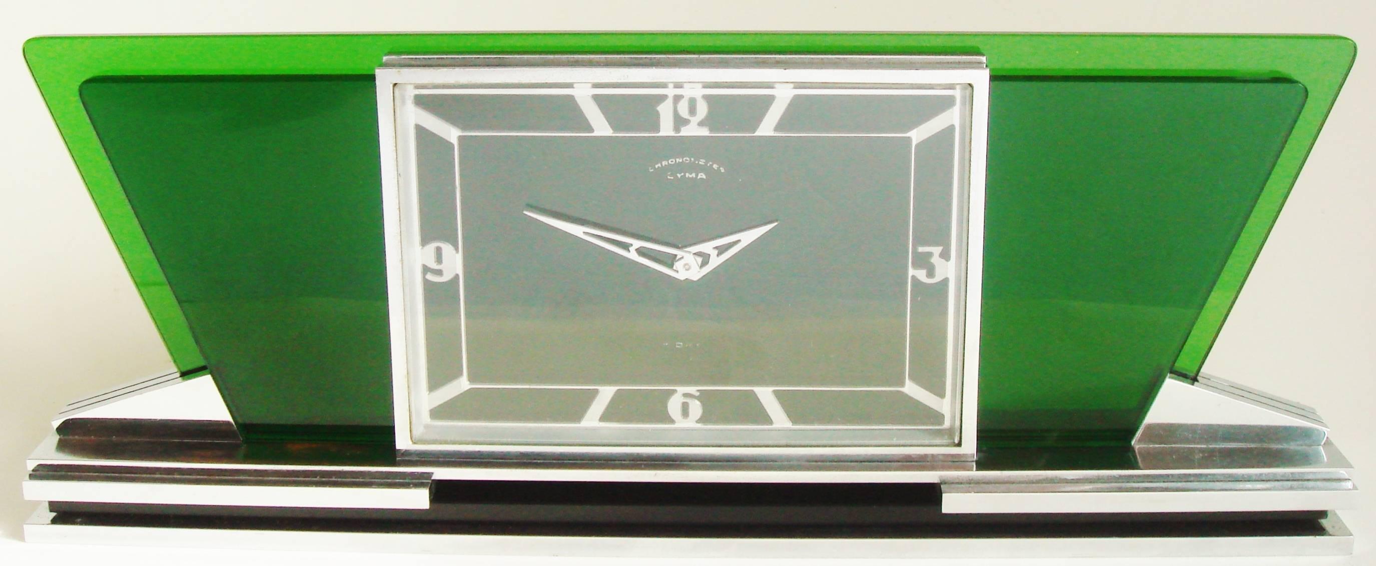 This truly beautiful Swiss Art Deco chrome mechanical desk chronometer is by the CYMA Company of Meyrin, Switzerland. Its angular chrome body is accented on either side with stepped two level 