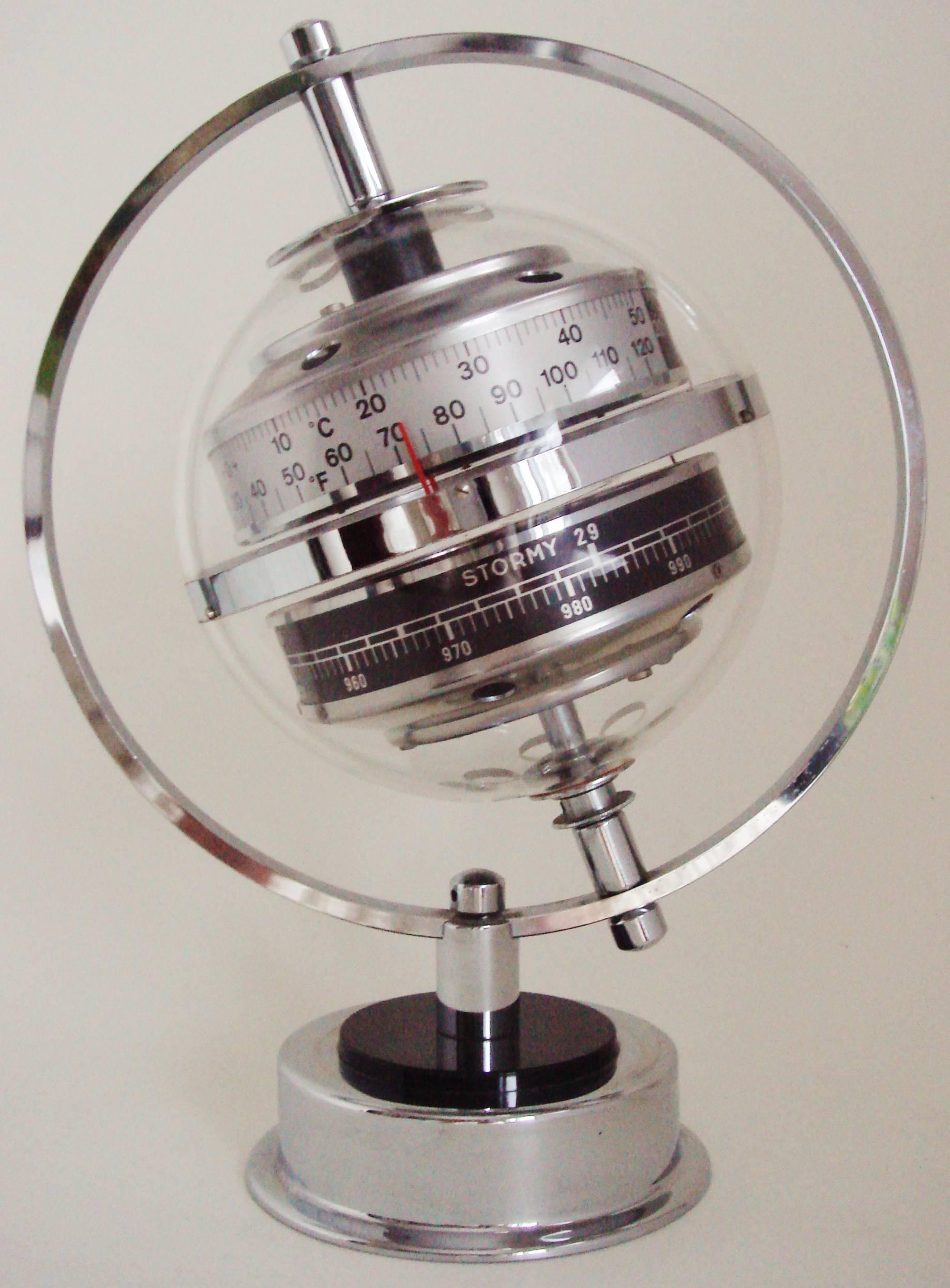 This beautiful West German chrome and Lucite desktop weather station is the stylish 1960s refinement of the iconic Sputnik weather station designed by Huber in the 1950s. It features a chrome planet ring that supports a clear Lucite globe that