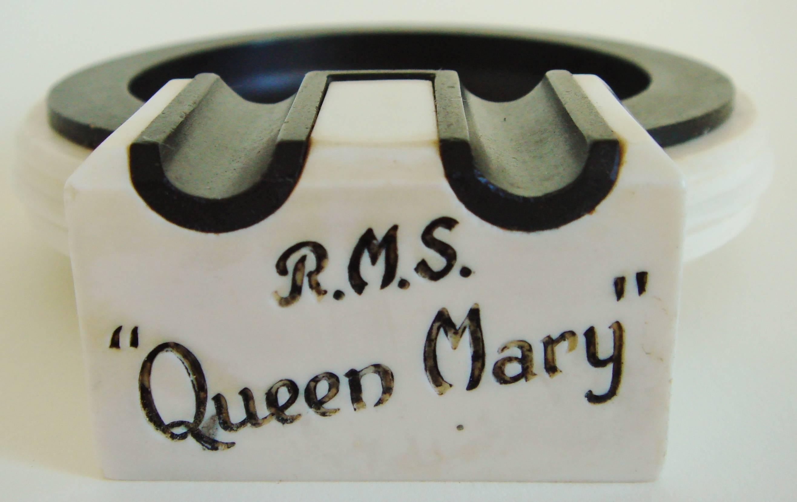 This rare pair of British Art Deco black bakelite and white phenolic resin ashtrays were made for the launch of the RMS Queen Mary in 1936. These models with 