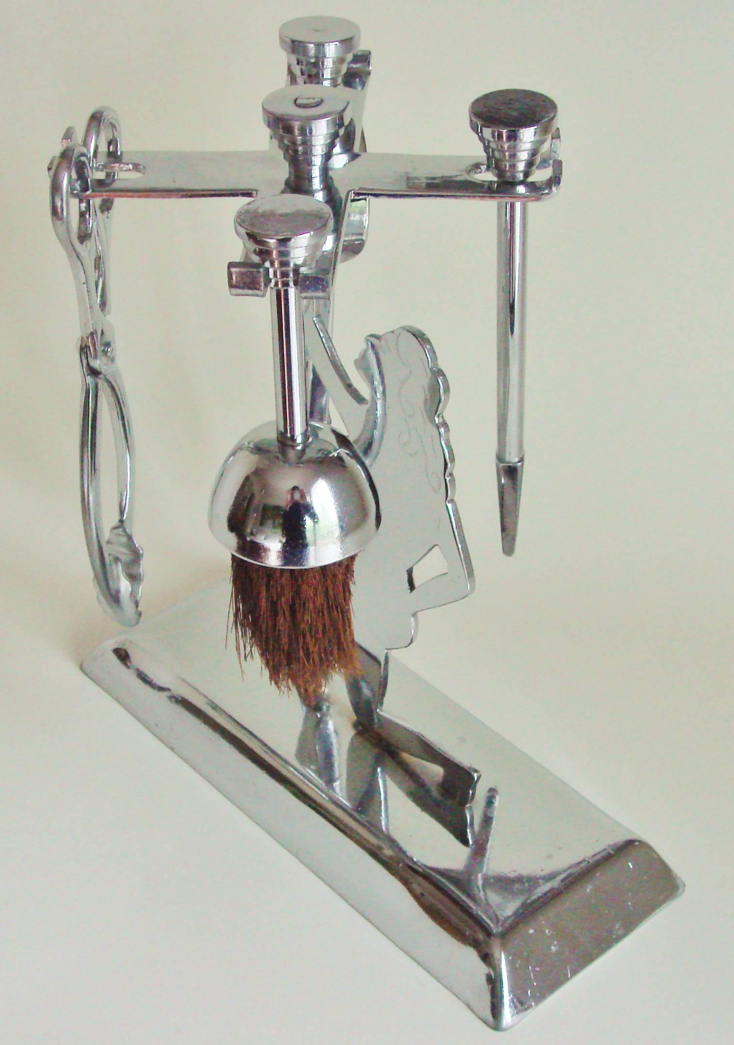 This charming English Art Deco, chrome-plated, trench/outsider art small companion or fire-tool set is comprised of a two dimensional nude female figure with incised details on either side. She kneels on a bevel edged plinth and in her raised arm is