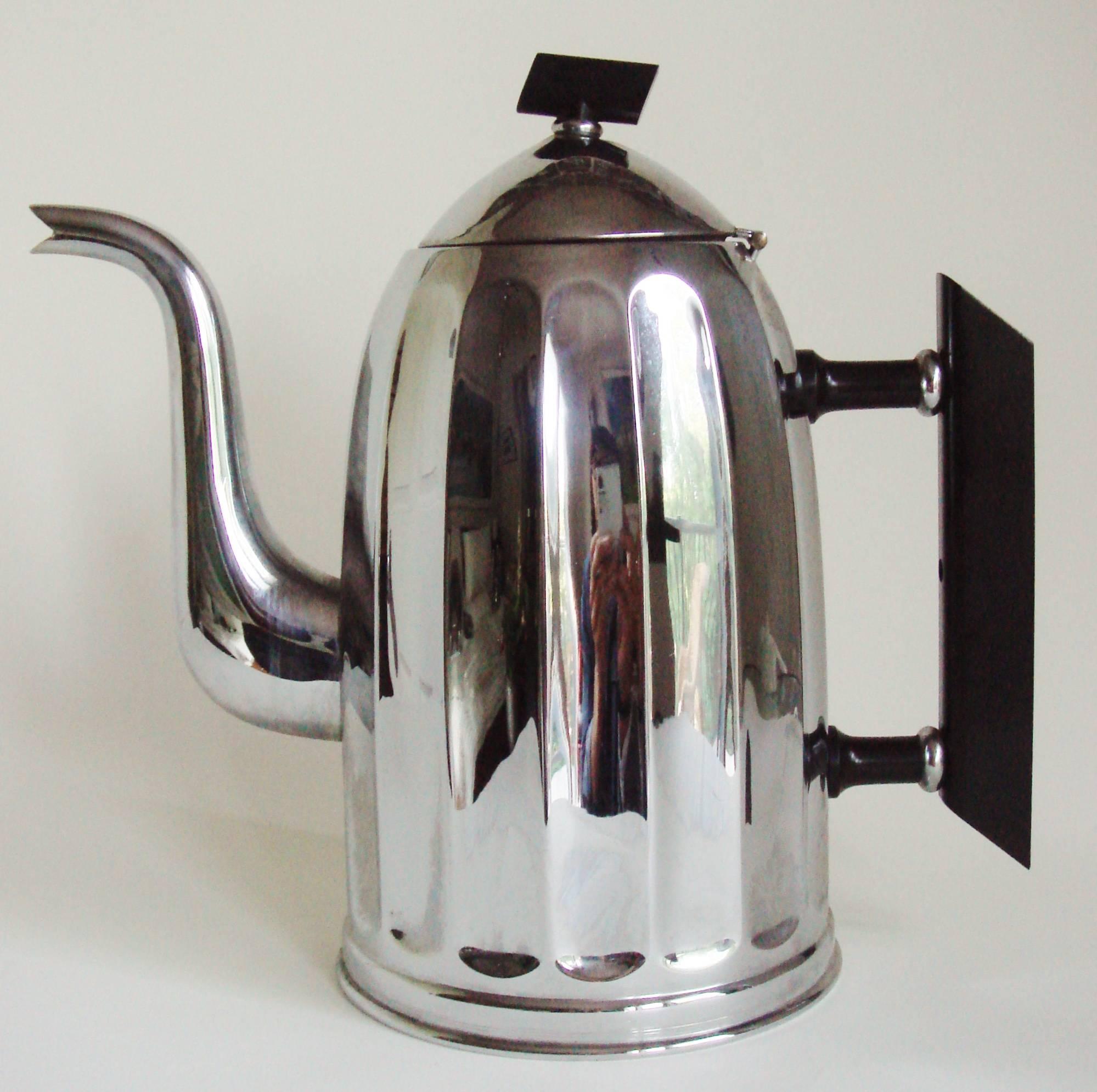 This iconic Art Deco chrome and black bakelite coffee set is by the famous Belgian metal ware company, Demeyere. The set features a large coffee pot (9.5