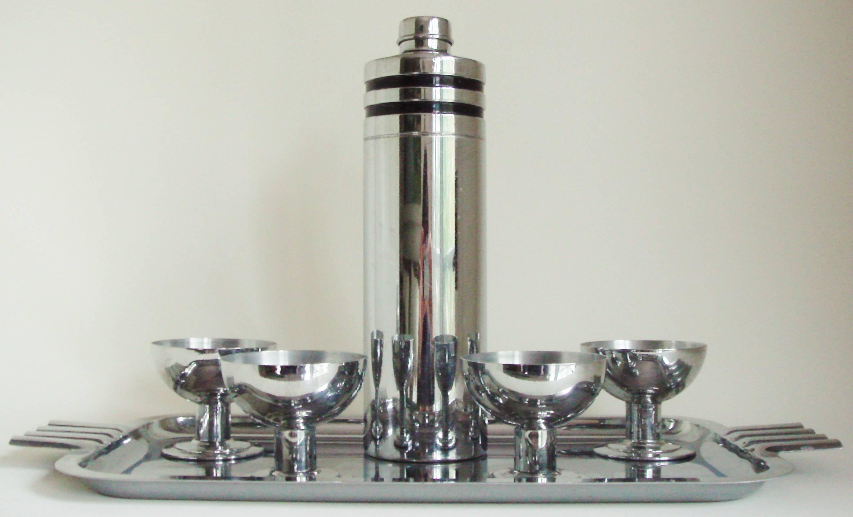 This American Art Deco six-piece cocktail set was probably assembled as a Christmas/birthday/wedding gift for a thoroughbred racing enthusiast and was made by Evercraft. The set is comprised of a black banded, signed Evercraft 'Town Shaker' cocktail