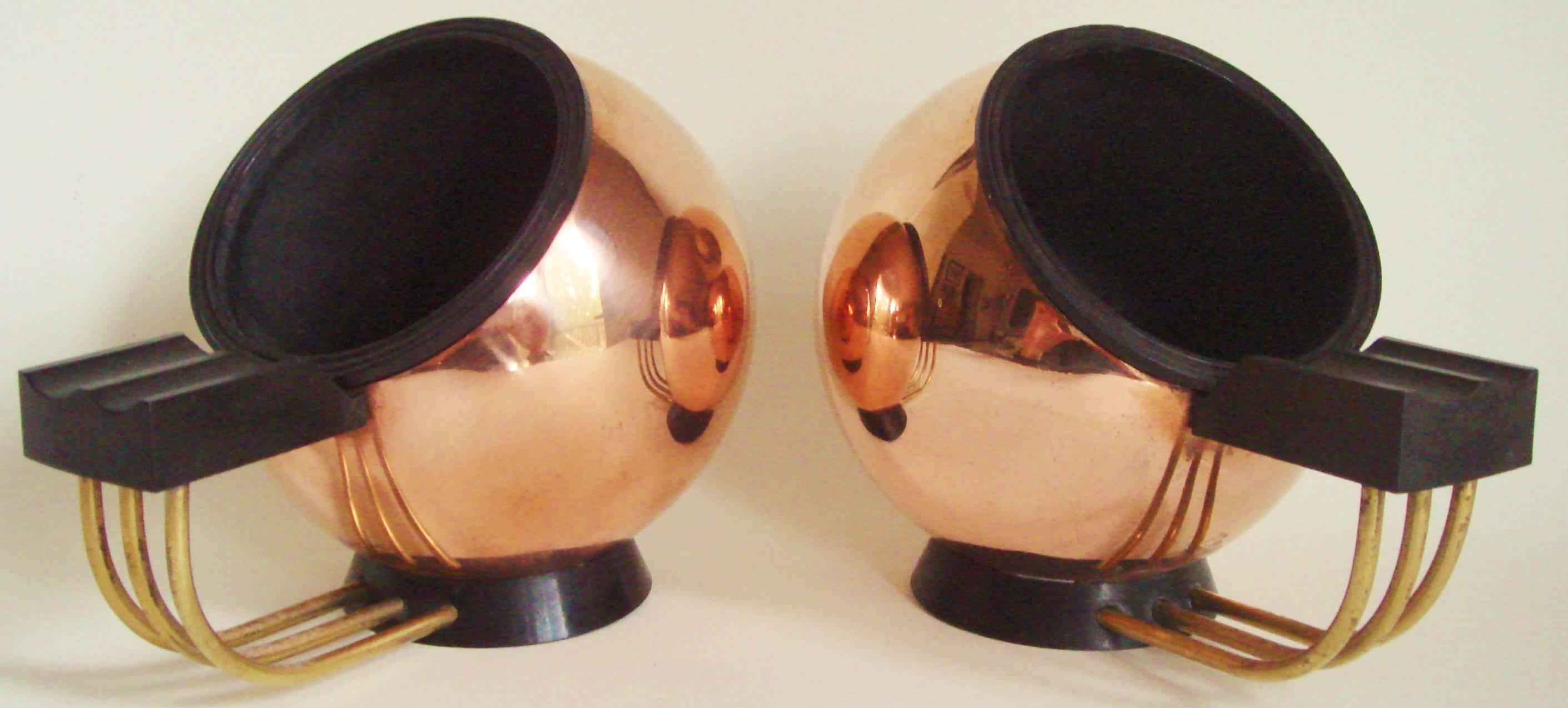 
This very stylish pair of Art Deco cigar/cigarette globe ashtrays is by the Belgian company, Demeyere and like the chrome and black Bakelite versions on our storefront are the table versions of their iconic smoker's stand. The difference is that