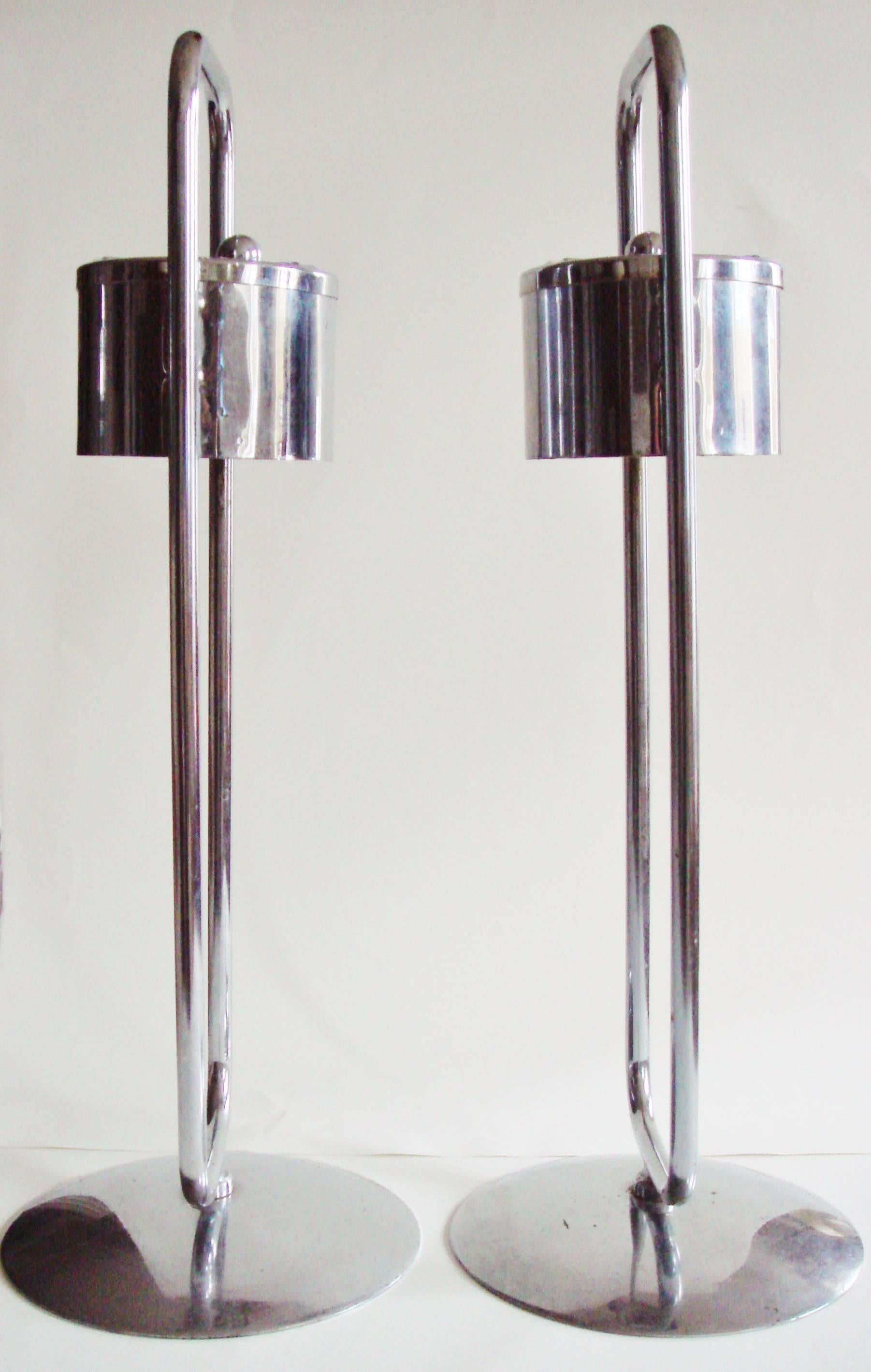 This stylishly designed pair of American Art Deco floor standing ashtrays were produced for use primarily in commercial spaces such as theatre/hotel lobbies and barbershops. They were manufactured in the 1940s by Royalchrome, a product line of the