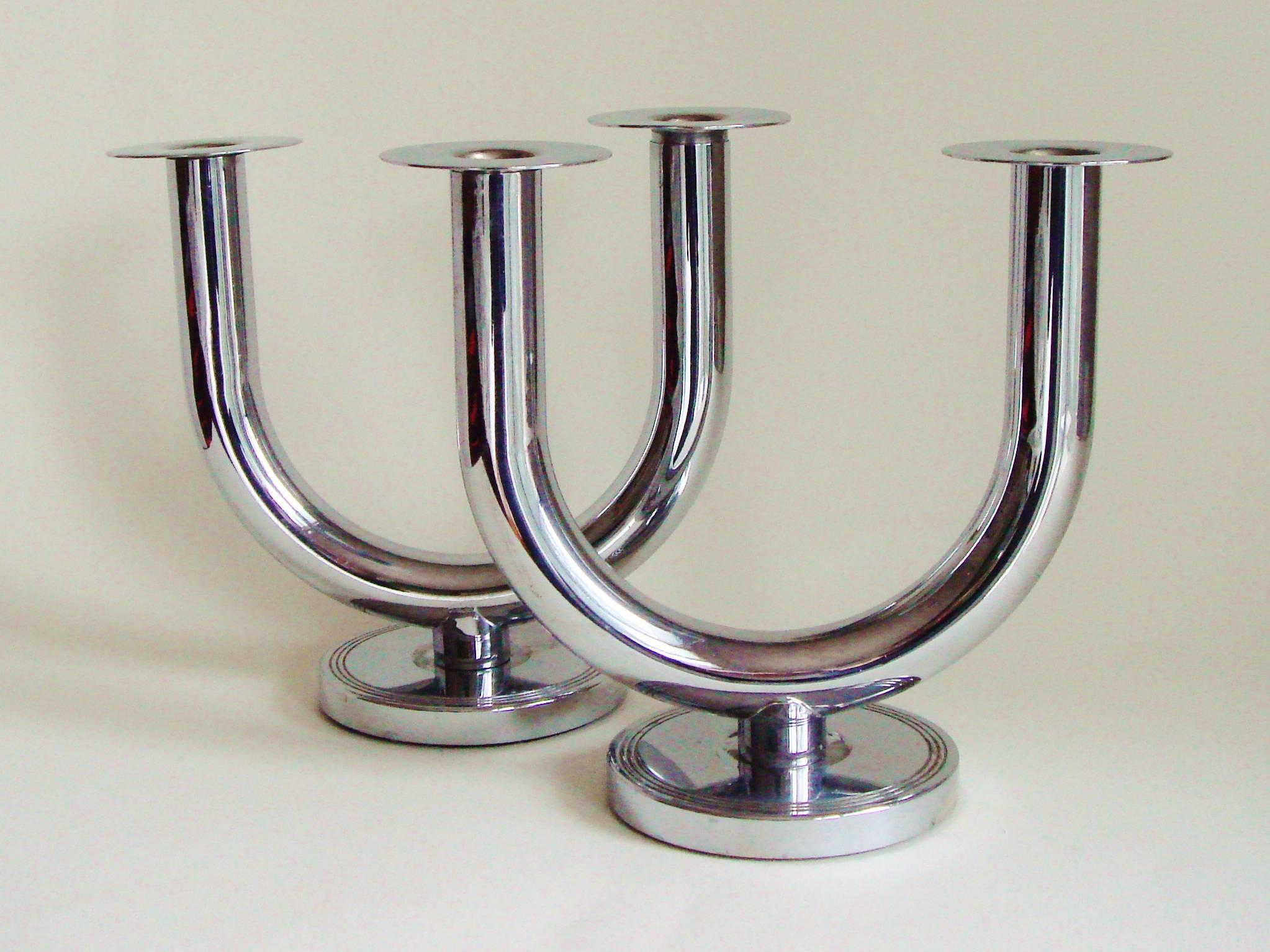 This set of four American Art Deco Taurex twin candlesticks were designed in 1933 by Walter Von Nessen for the Chase Brass and Copper Company of Connecticut. This group has examples of both the even model and the uneven model. They are designed to