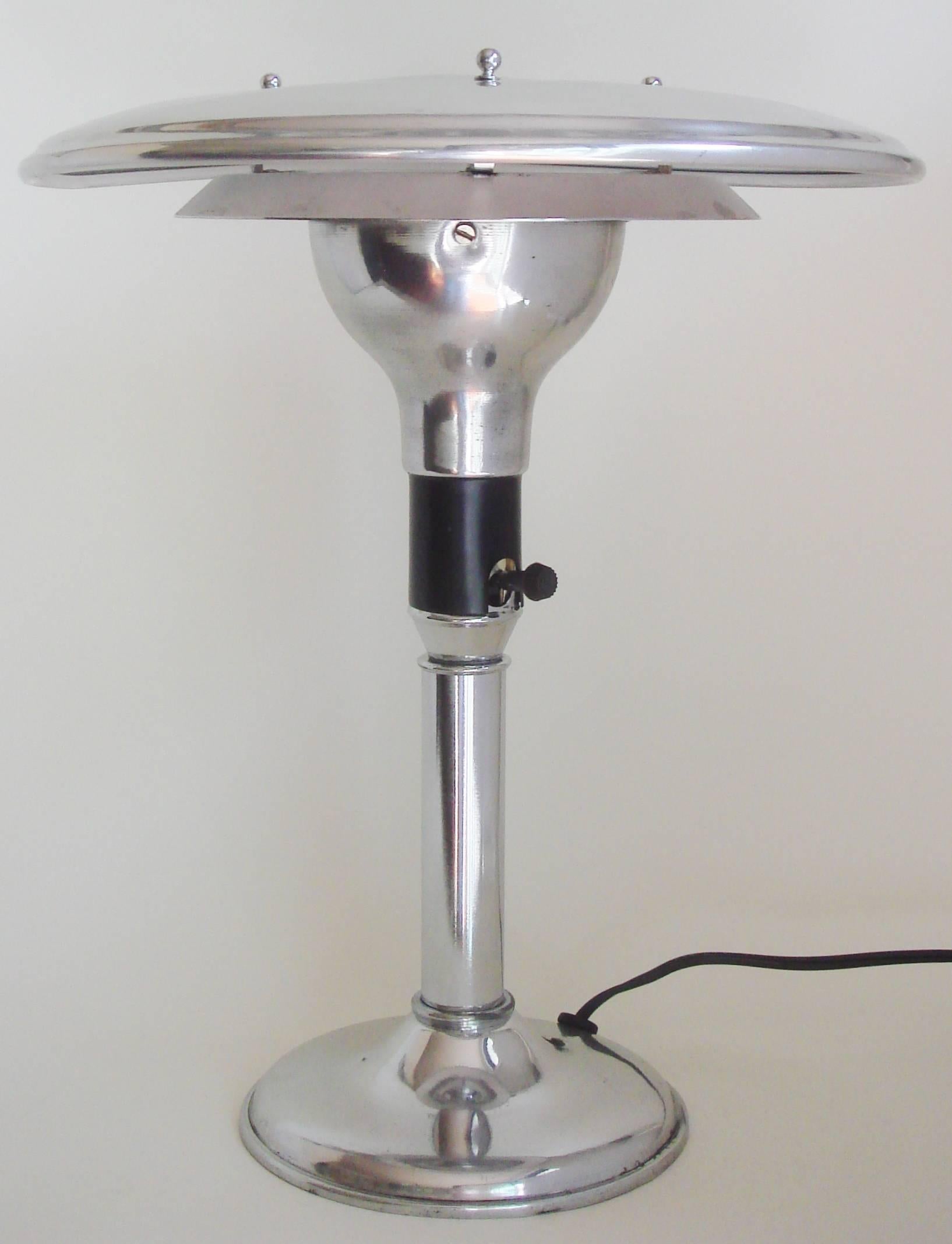 We are listing these two American Art Deco restored chrome, polished aluminum and black Sightlights as a pair as they are almost identical albeit with very subtle differences (most notably a raised single dimple in the center of one shade and