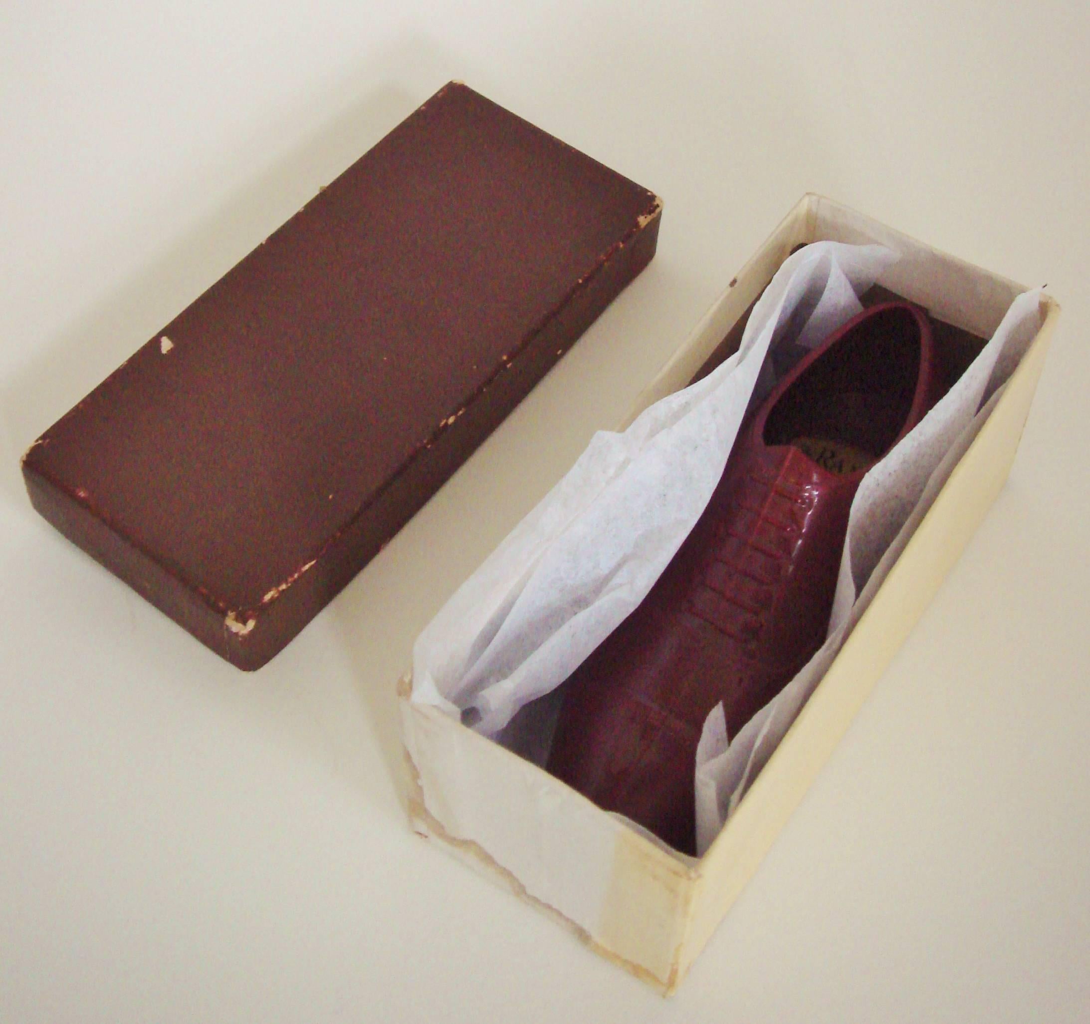This American Mid-Century four and a half inch long salesman sample, chestnut brown plastic, elegant Oxford shoe was manufactured by American footwear giant, the Roberts, Johnson and Rand-International Shoe Company. It bears a transfer on the inside