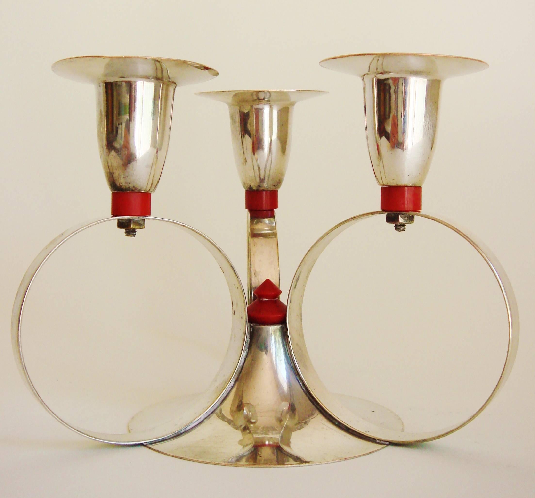 This stylish pair of American Art Deco silver plated copper, triple hooped candle holders feature red Bakelite accents. They are unmarked but are obviously a high quality pair from an excellent maker. The silver plating is near perfect with no