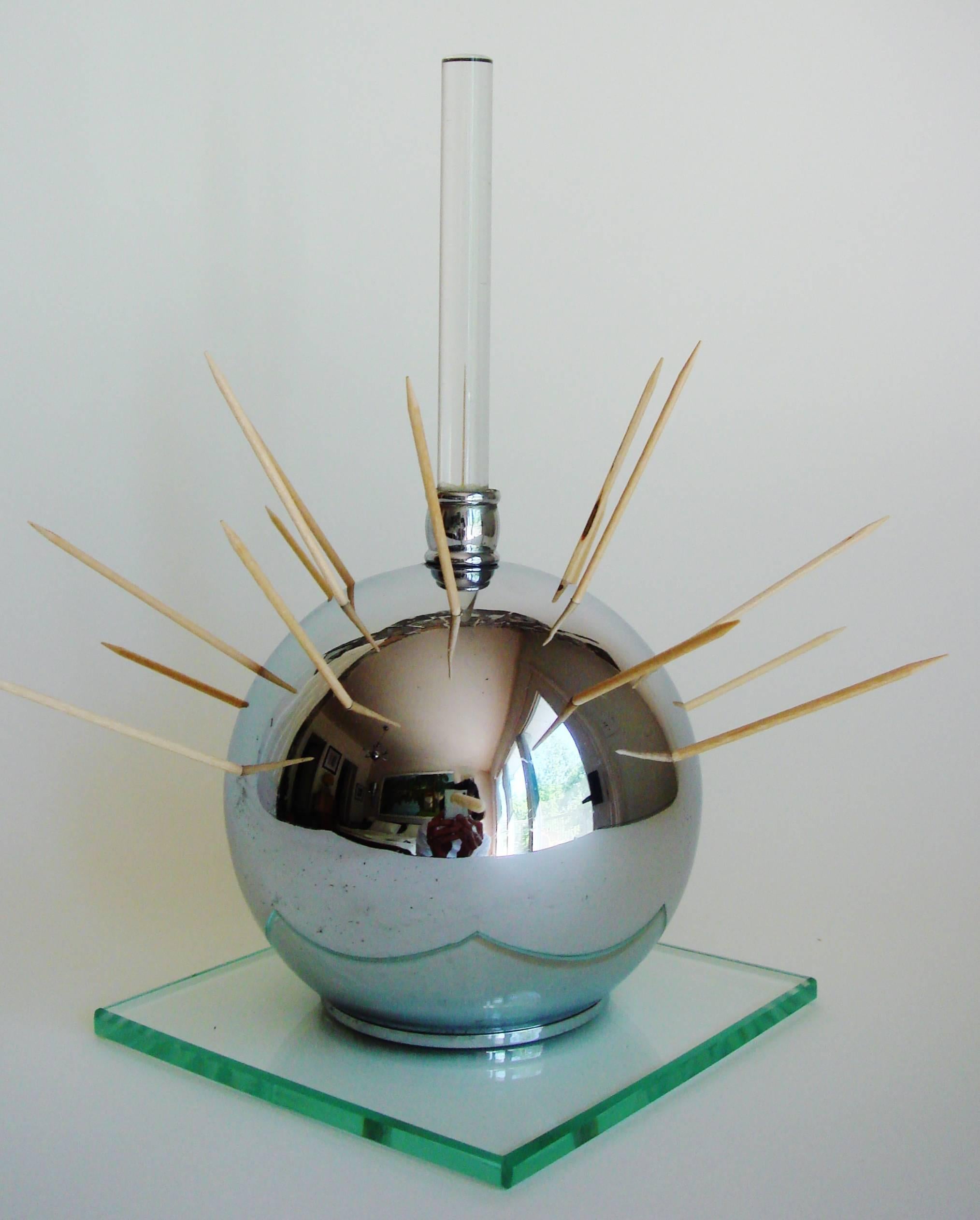 This large American Art Deco cocktail ball was designed to enable the perfect Hostess/host to elegantly offer hors d'oeuvres to guests. It features a crystal rod handle that rises from a pierced chrome sphere which in turns sits on a beveled edge