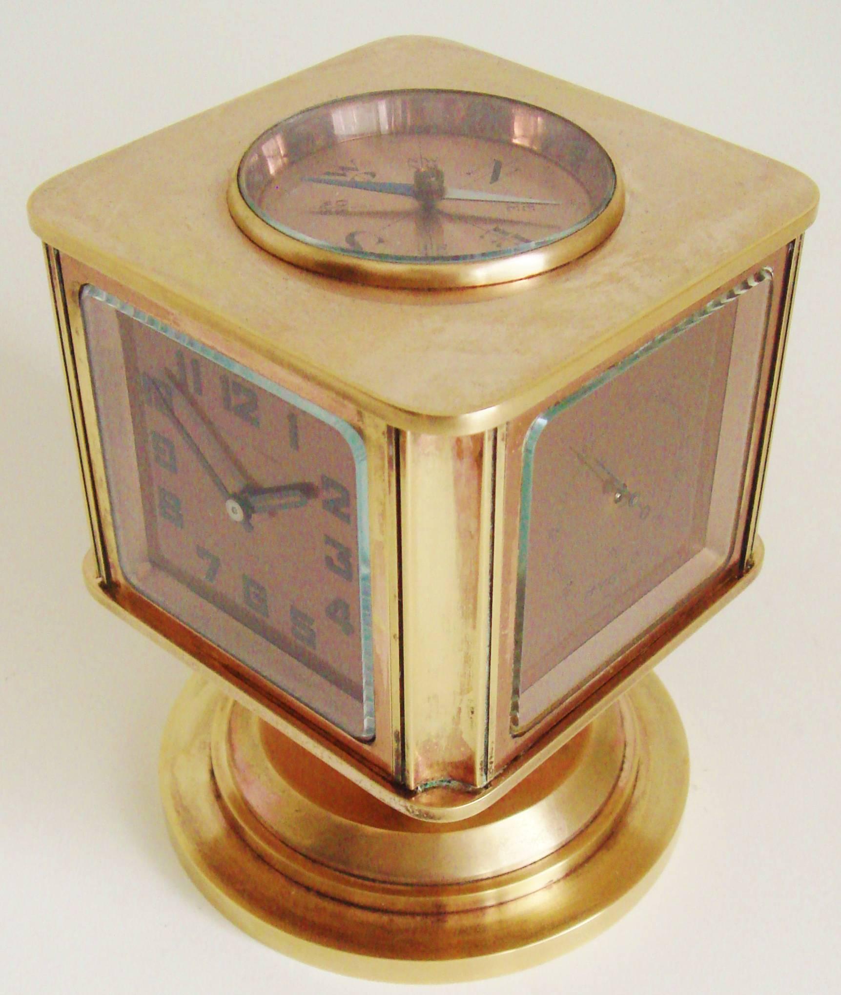 This rare Swiss Art Deco compendium five in one desk clock, Celsius or Fahrenheit thermometer, barometer, hygrometer and compass is the Meteo by the Angelus Watch Company. It is an earlier model featuring an milled edged external crown to adjust the