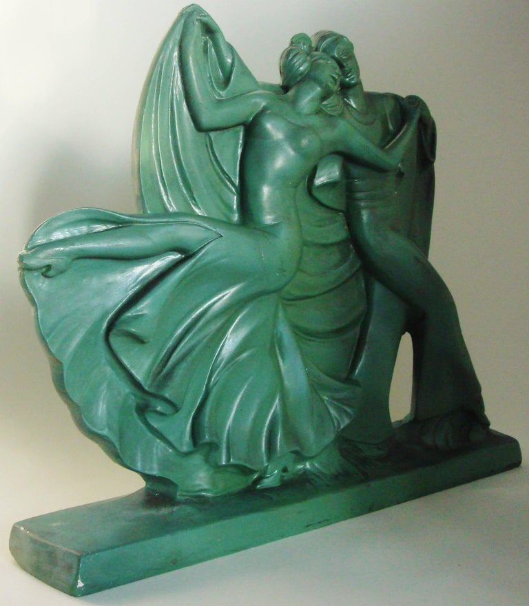This English Art Deco statue features a male and female performing the French cabaret Danse Apache and is a rare example from The Ornamental Plaster Company's dance series. This piece was designed to be placed against a wall as the front of the