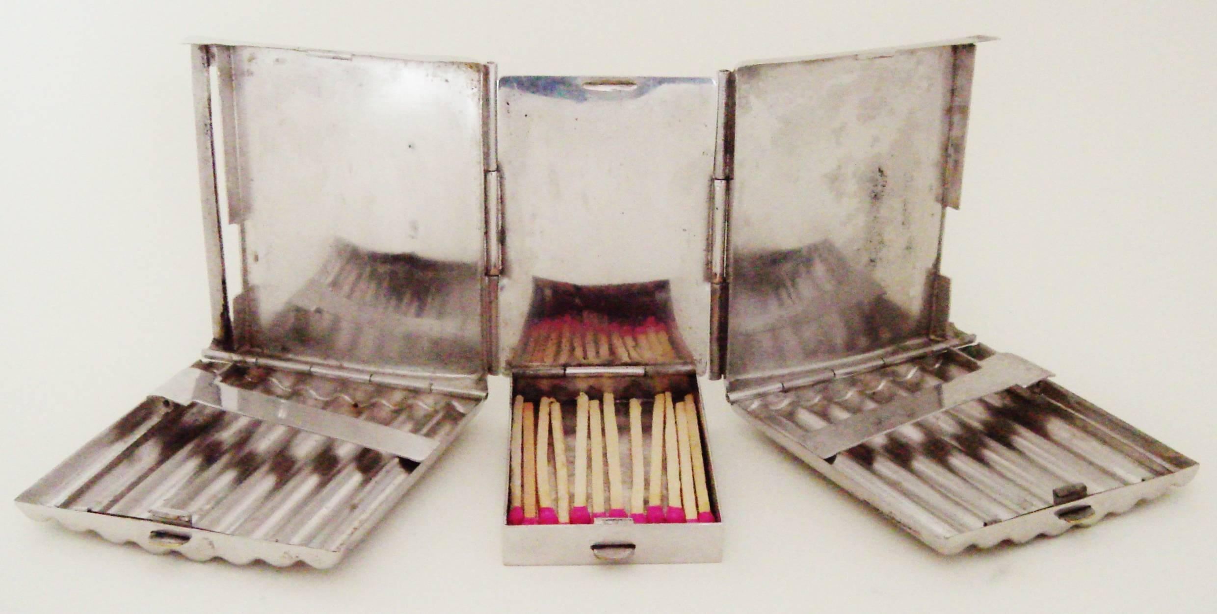 An intriguingly designed and rare American Art Deco chrome combination cigarette case, match safe and belt buckle. It features twin segmented cigarette cases each holding eight cigarettes and are joined by hinges to a centrally mounted match safe