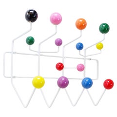Wall-mounted coat rack with colorful balls and metal frame, "Hang It All" Style