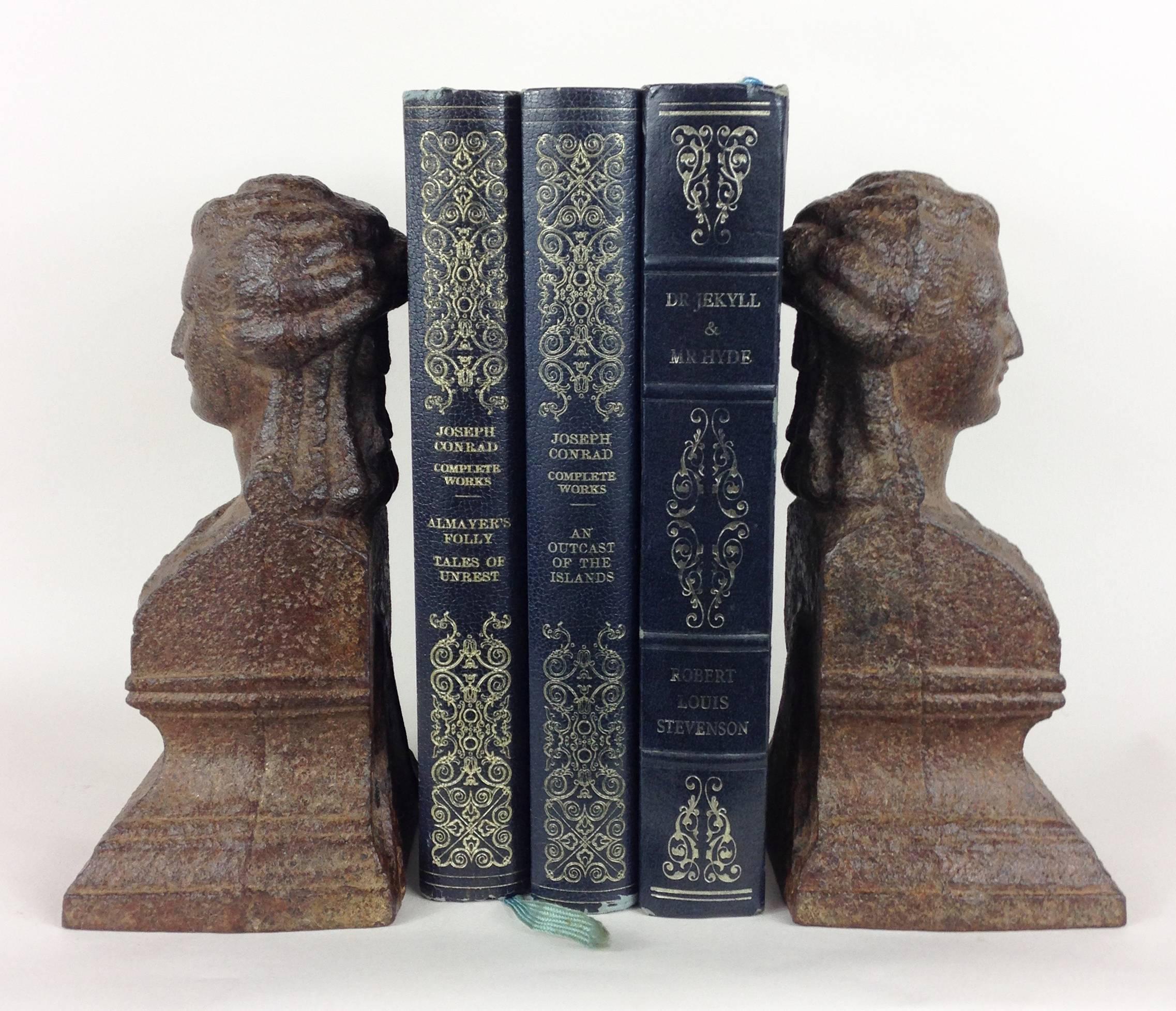 A fine pair of cast iron Regency period bookends depicting female heads.

Due to the incredible weight of these pieces (combined weight of almost 9Kg) they could feasibly be used as two individual door stops. Lead filled cast iron forms with
