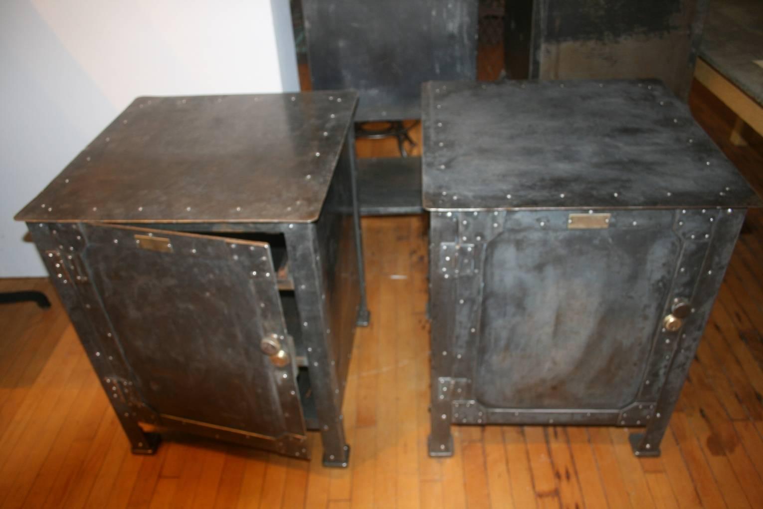 Awesome pair of steel cabinets. They are made of heavy gauge steel and are very heavy almost as if they were safes. The riveted steel has the best dark patina. I couldn't catch it in the photographs. Each cabinet has a wooden drawer on top with two