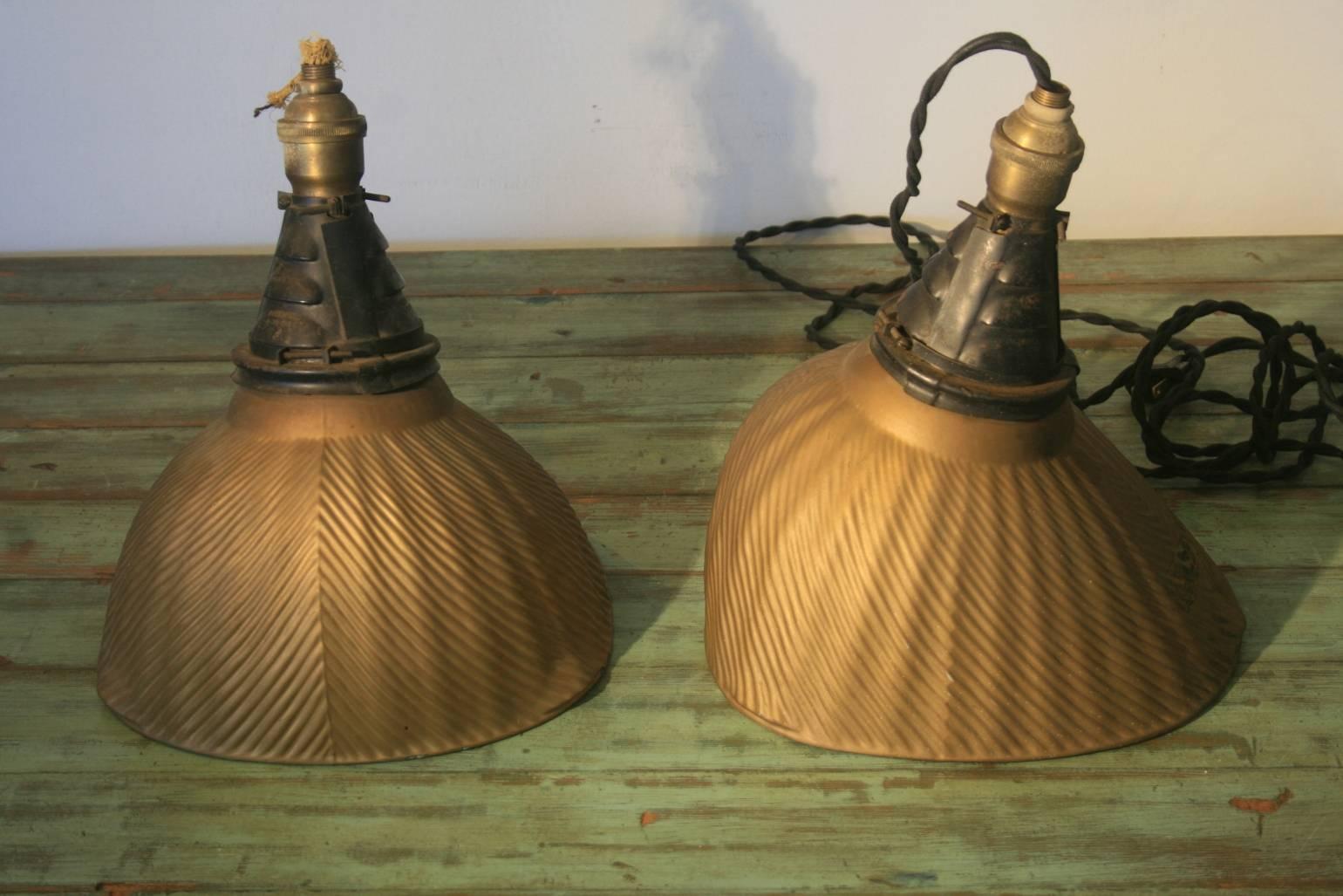 Six Mercury glass industrial shades made by the X-Ray Co. They have the original cone shaped black holders and sockets. They are all in excellent condition with no losses to the mercury or gold painted exteriors. They are beautiful as objects and