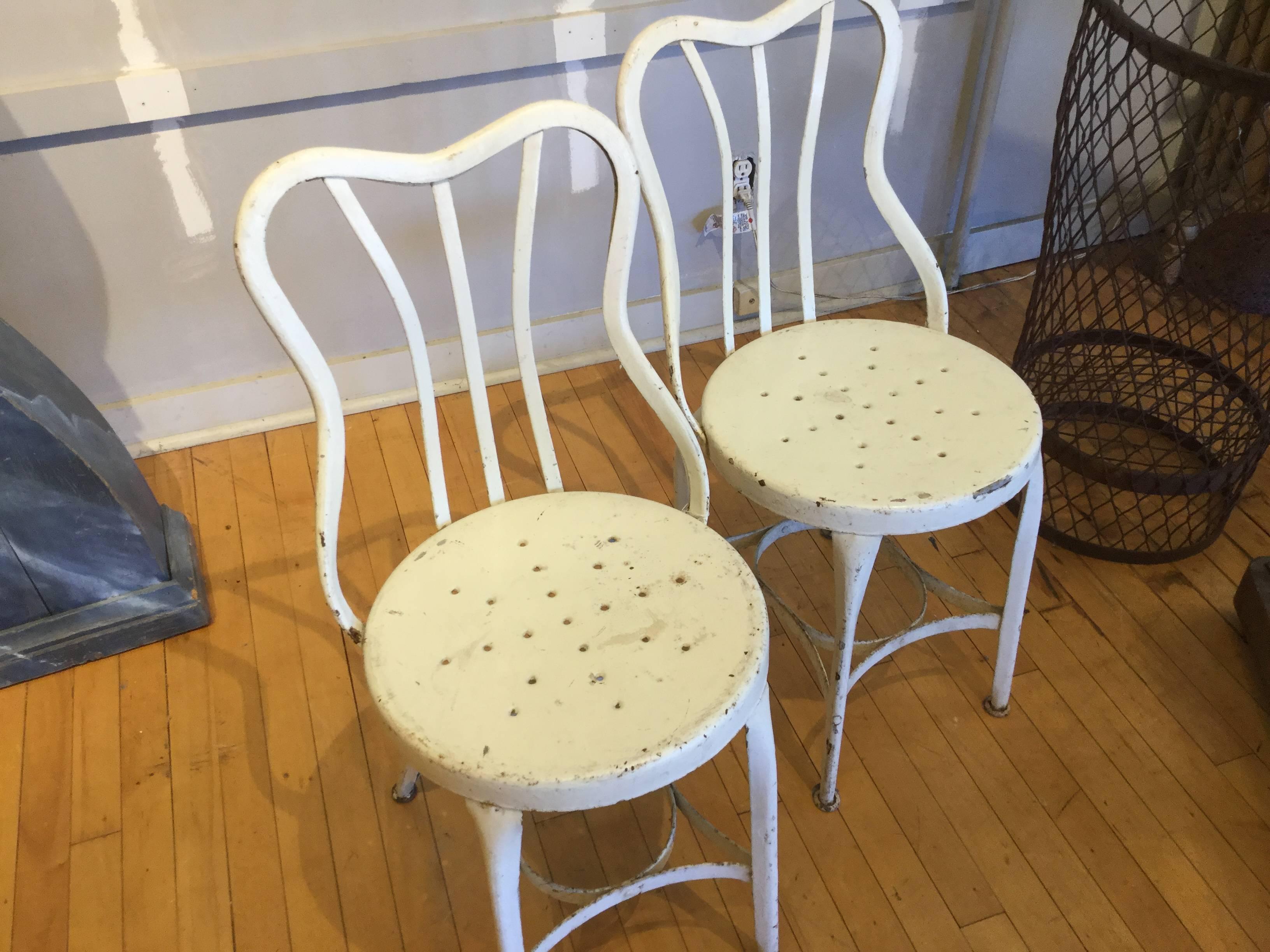 These are my favorite chairs. Made by the Toledo company in Toledo, Ohio, circa 1900. There are several versions of these chairs. These have steel seats with perforations. Some had wooden seats with perforations.