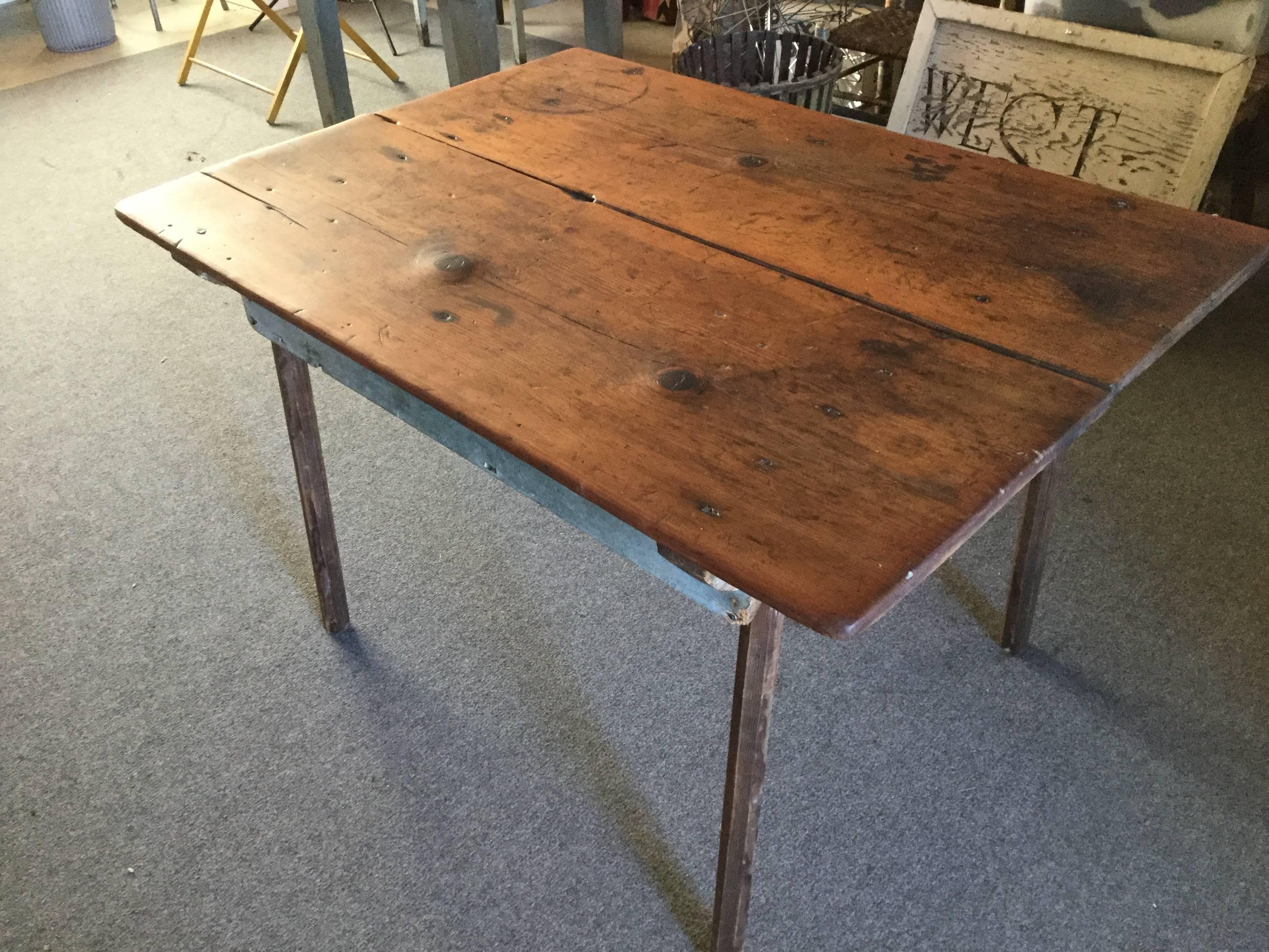 19th century American primitive table with wide boards for a top. The wide boards are pine and probably from the 18th century. Lumber this size was once known as the Kings Lumber, because any lumber this wide was supposed to belong to the King of