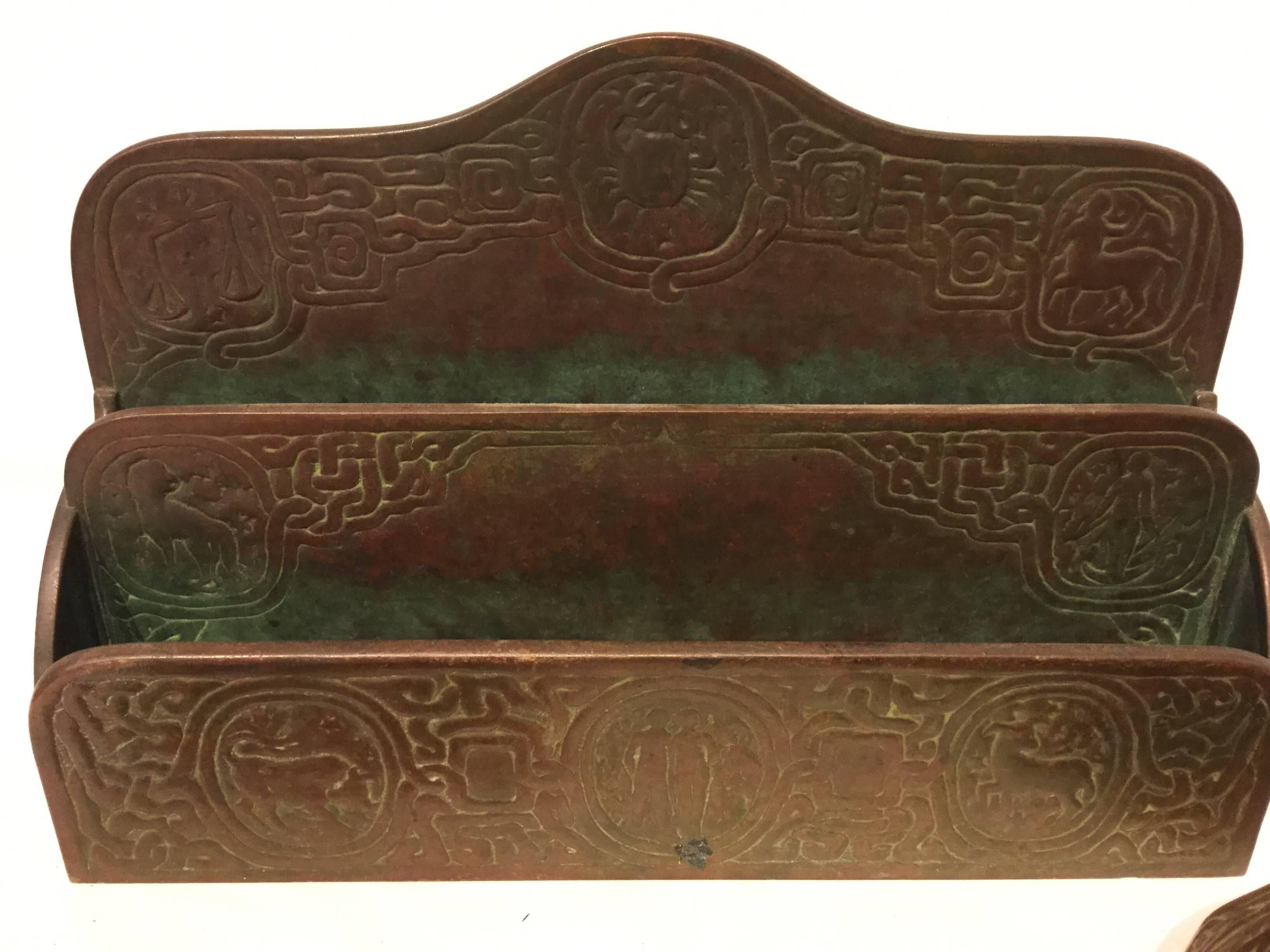 Beautiful patina on this four-piece Tiffany Zodiac bronze desk set. Made by Tiffany c 1905 at the height of the arts and crafts movement. The astrological motif design on the set was aptly named 