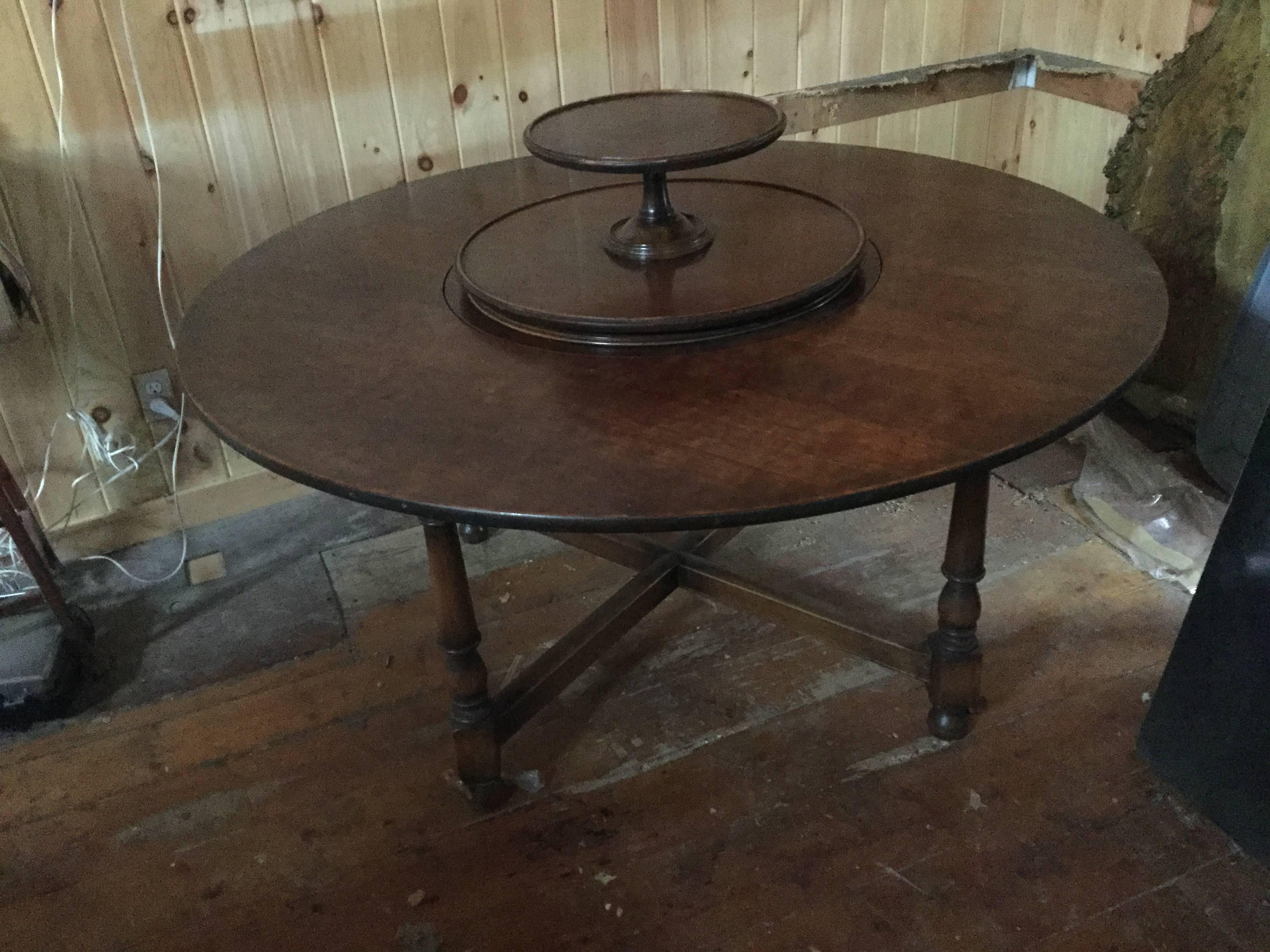 Beautiful cherrywood round dining table with hidden Lazy Susan. This table has a beautiful patina, can seat eight and has a double deck Lazy Susan that can hide under the flat surface or revolve.