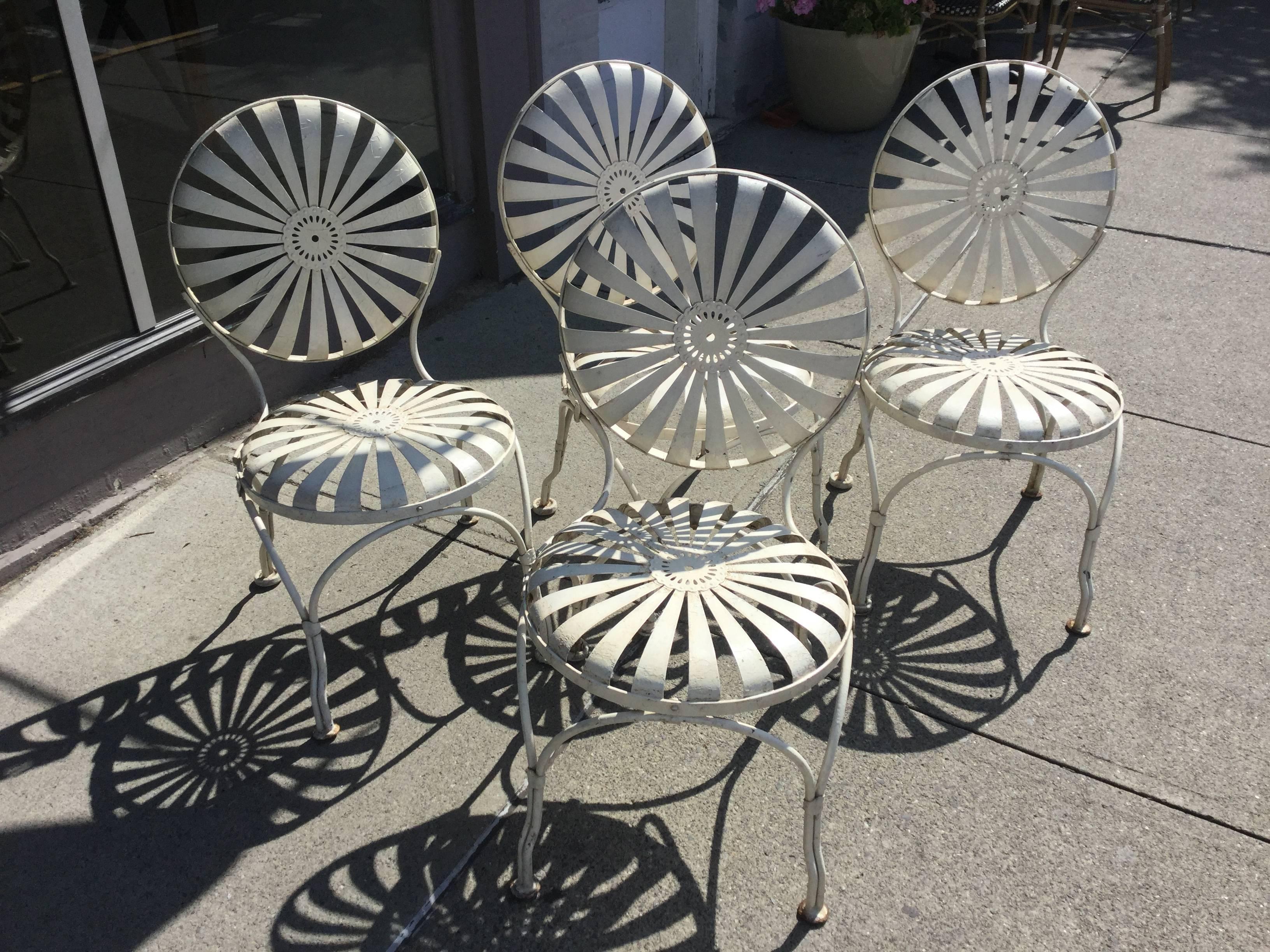 Set of four French patio chairs by Francois Carre, circa 1920. This set is is the best original condition I've ever found. They even have the original Paint. Best looking Garden Chairs ever. Also called springer Chairs or sunburst Chairs. The