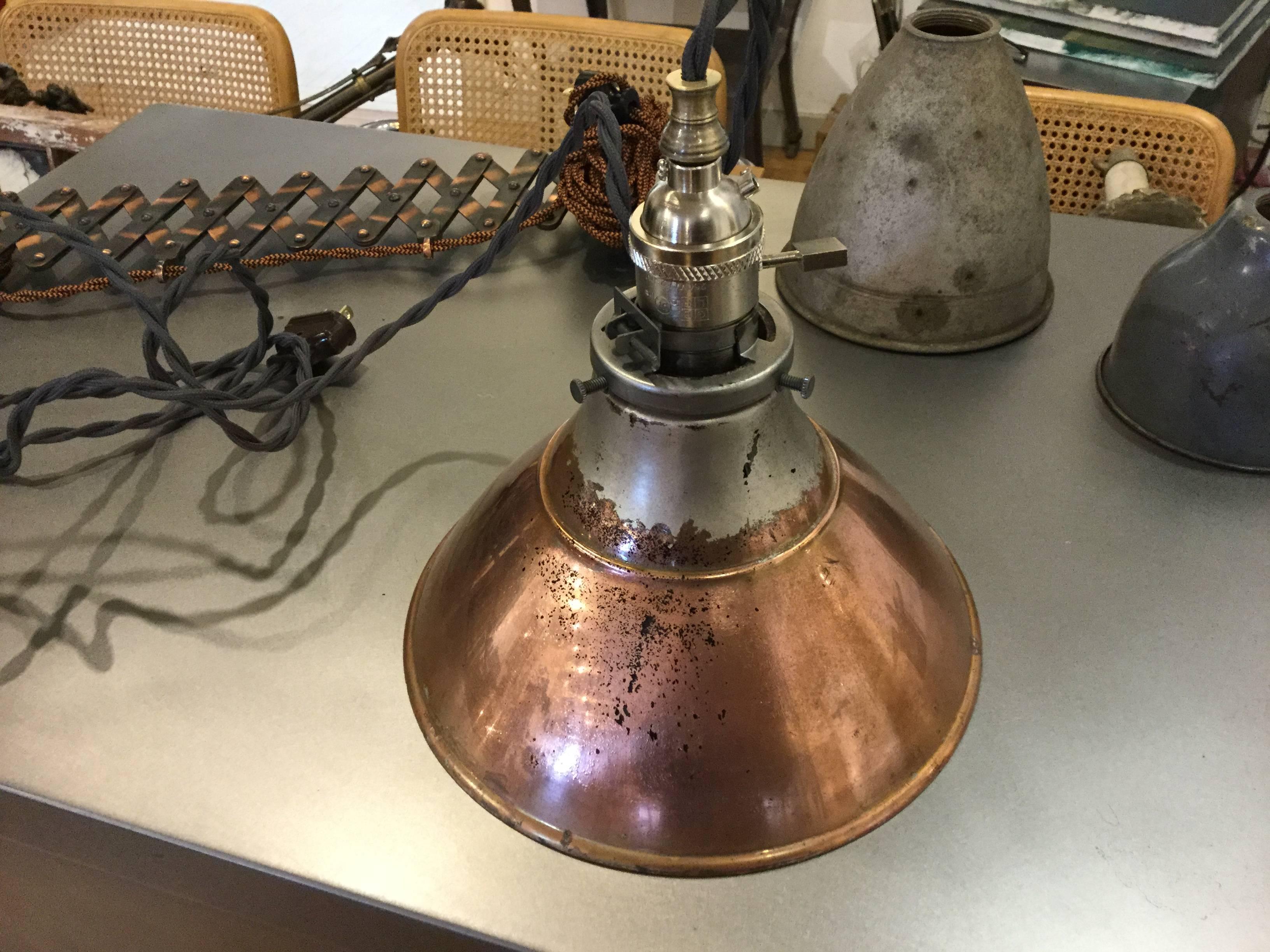 Mercury glass industrial pendant light. The copper on the shell of the shade has a beautiful patina. Inside is the Mercury glass. The light has brand new wiring plug, and socket. It’s ready to install.