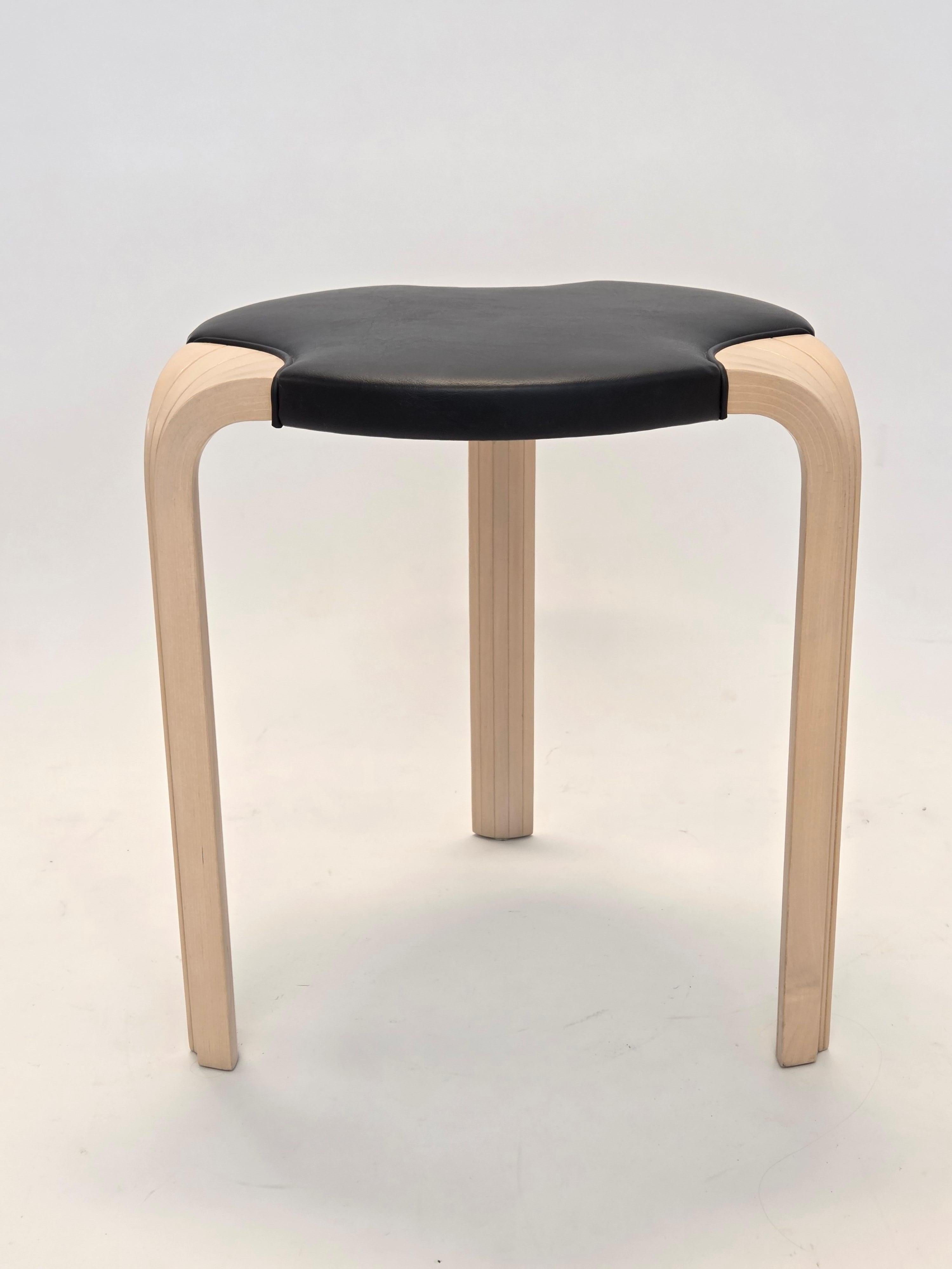 Artek X600 stool, designed by Alvar Aalto. Birch with black leather upholstery. In very good used condition. The stool has been restored.

The Artek X600 Stool is designed by Alvar Aalto in 1954. The stool features solid wood construction. Aalto's