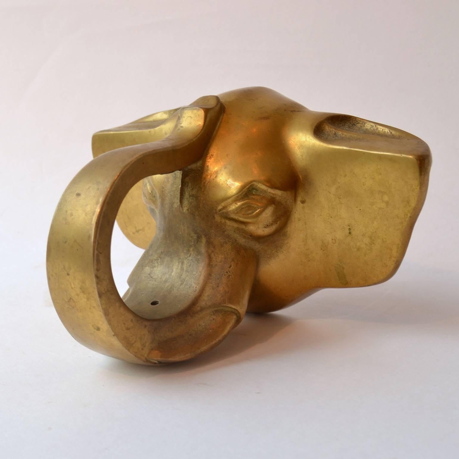Door handle, solid cast bronze , of a large elephant head with trunk as grip. it is to be mounted in the middle of the front of an entry door on top of a plinth or raised edge. This decorative handle came from Art Deco oak front door in the